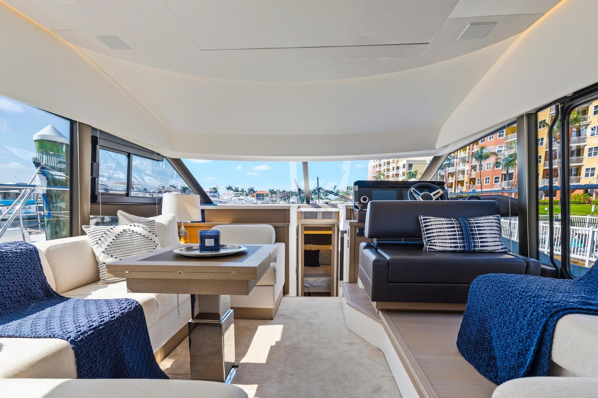 Luxurious interior of 2022 Prestige 520 yacht with elegant seating and modern design.