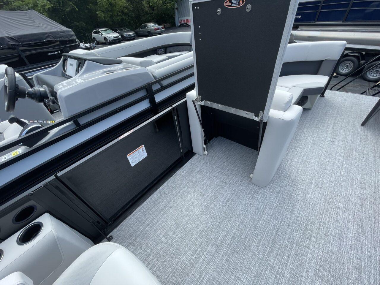 2026 Harris Cruiser 230 interior with gray seating and flooring, showcasing modern design.