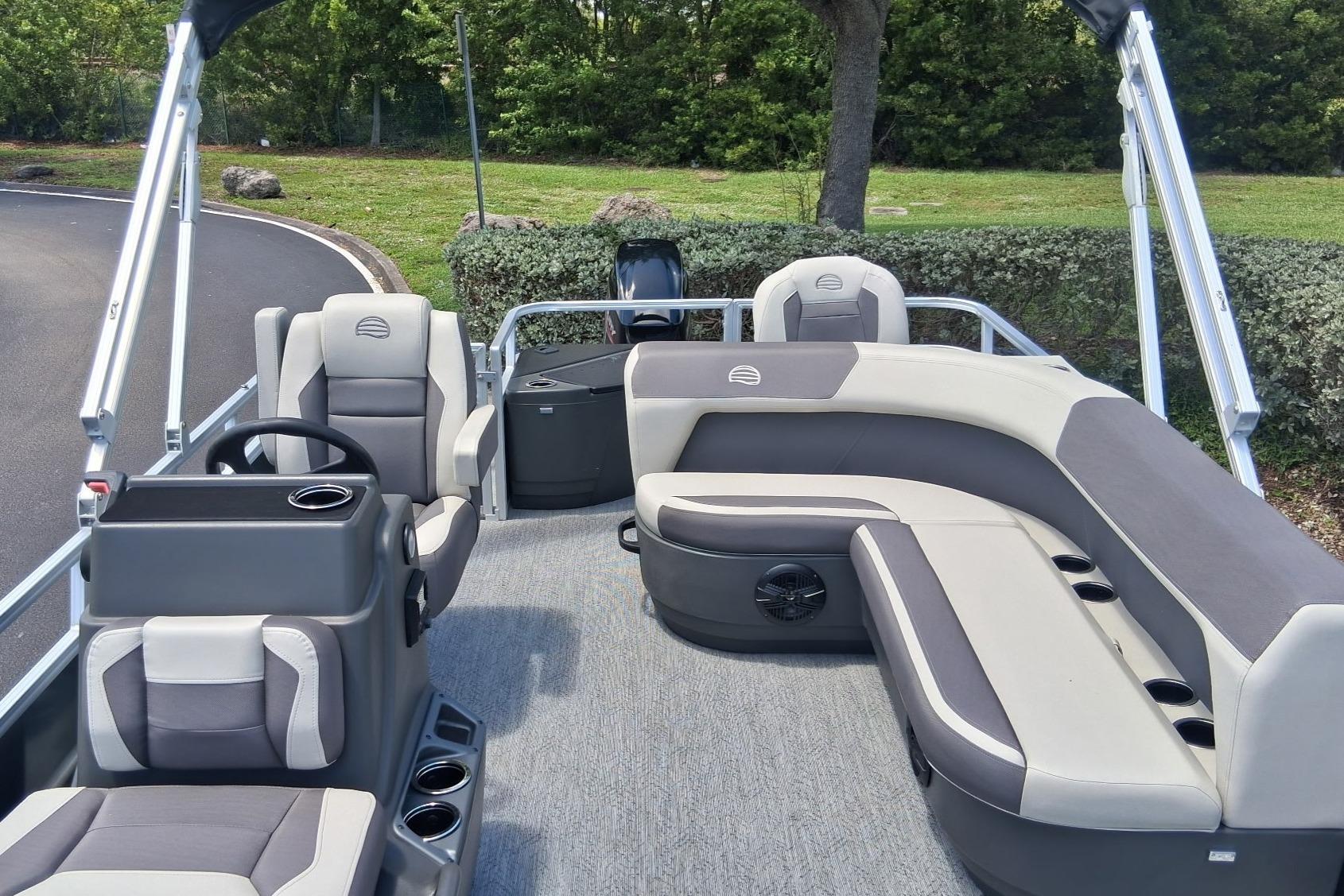 2026 Sun Tracker Bass Buggy 18 DLX pontoon boat interior with plush seating and steering console.