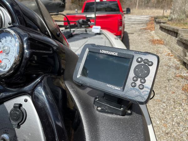 2021 Tracker Pro 195 XTE boat with Lowrance Hook fish finder and red truck in background.