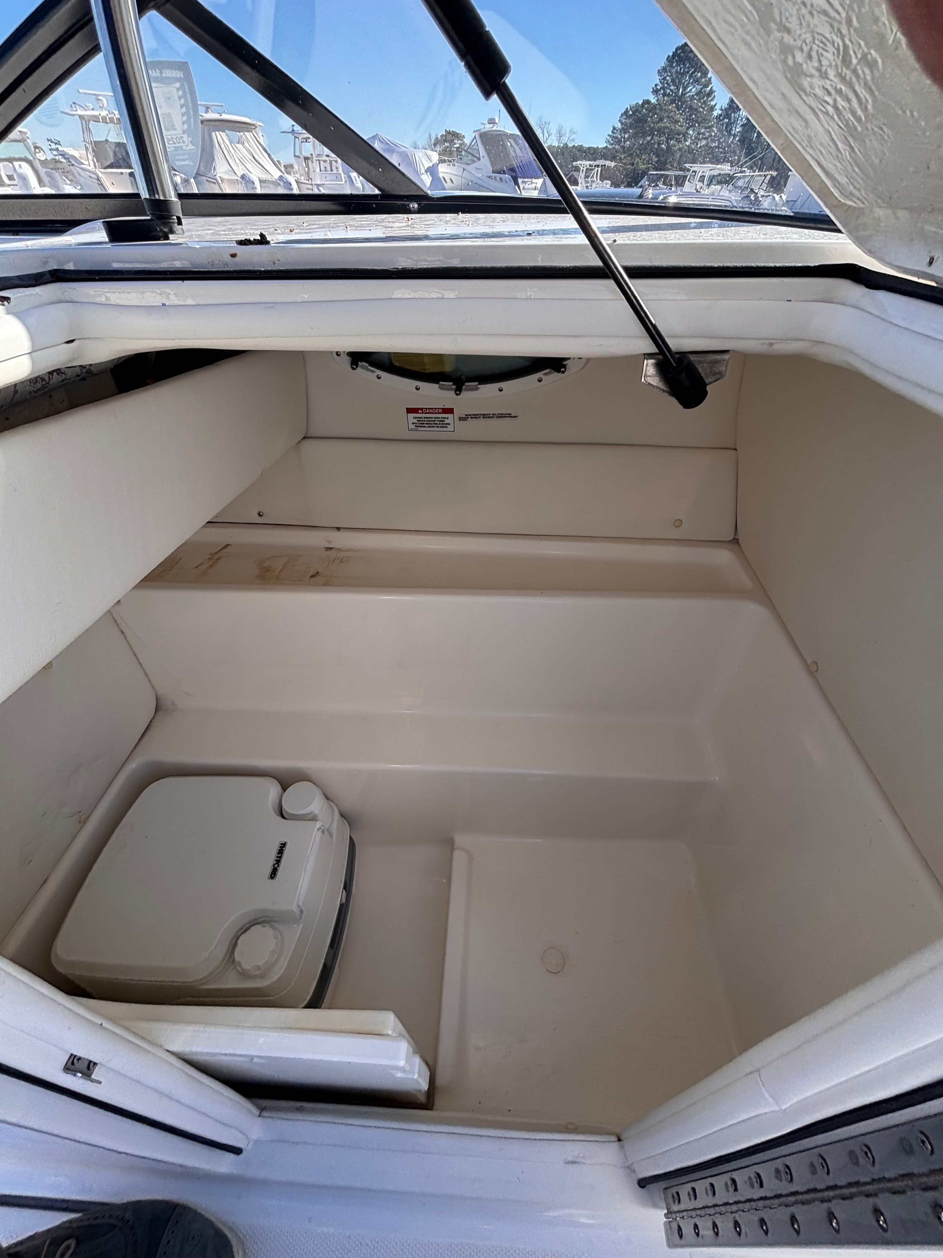 Interior of 2024 Bayliner VR6 Bowrider OB with storage space.