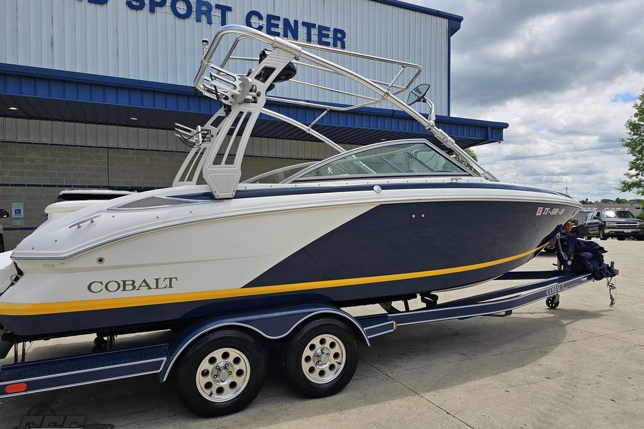 2010 Cobalt 232 WSS boat on trailer outside a sport center.