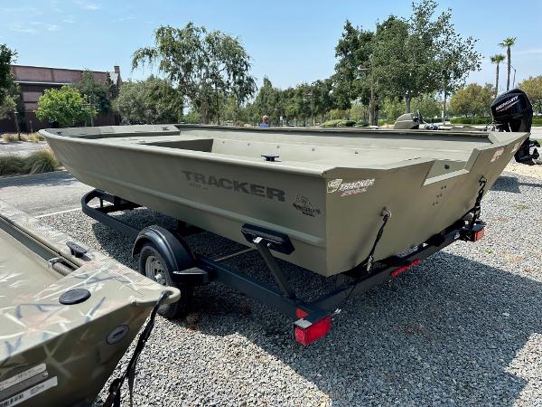 2025 Tracker GRIZZLY 2072 Utility boat on trailer, parked outdoors.