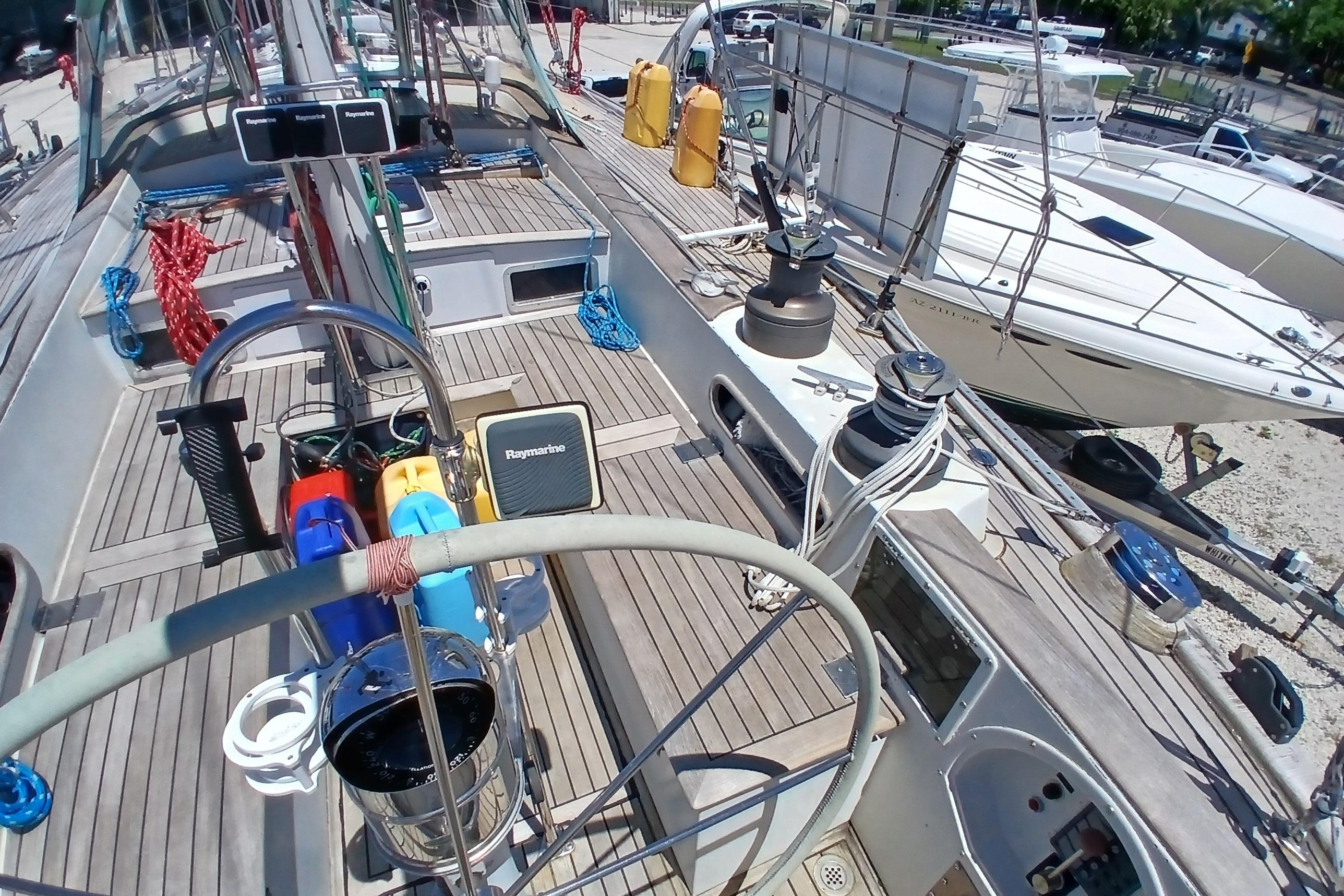 1981 Kaufman Skye 51 sailboat deck with steering wheel and navigation equipment.