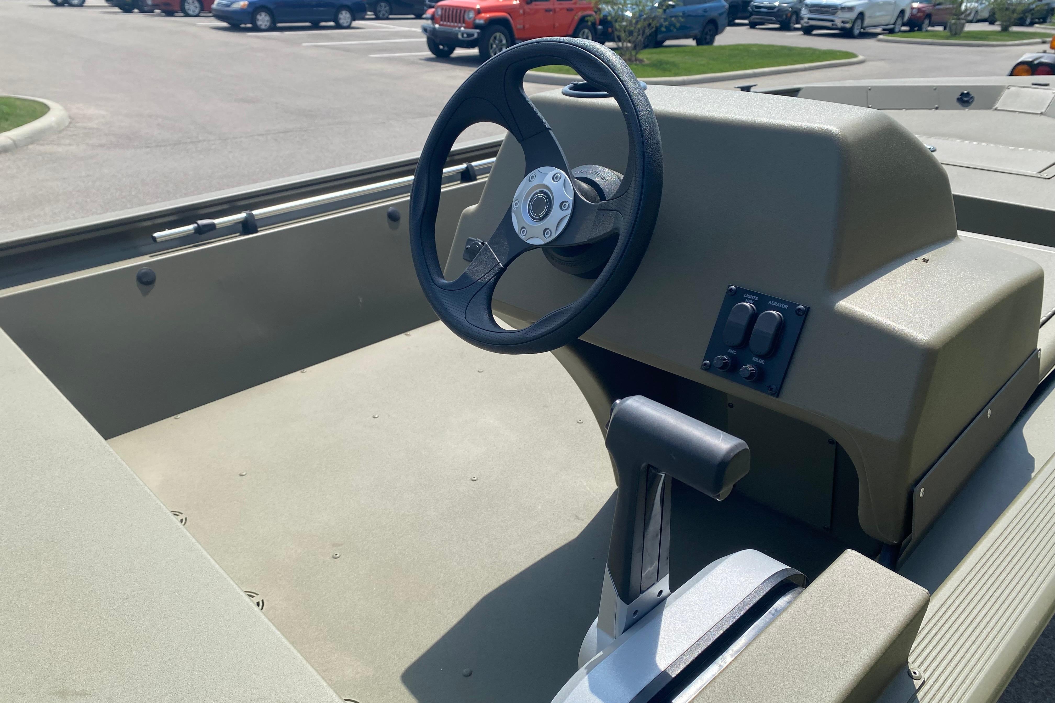 2026 Tracker Grizzly 1648 SC boat interior with steering wheel and control panel.