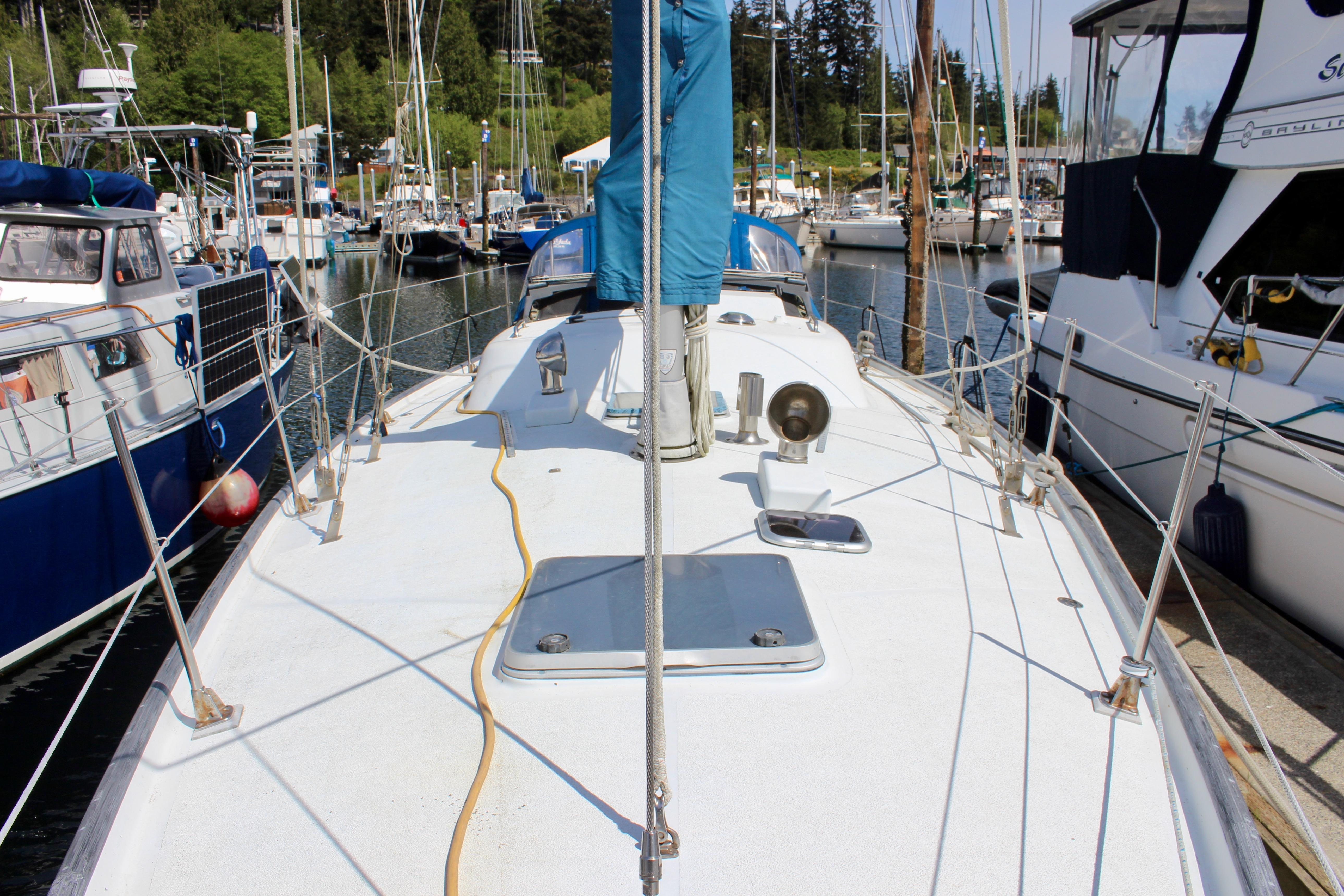 Sailboat docked in marina, Freya 39 model, 1993, surrounded by other boats.