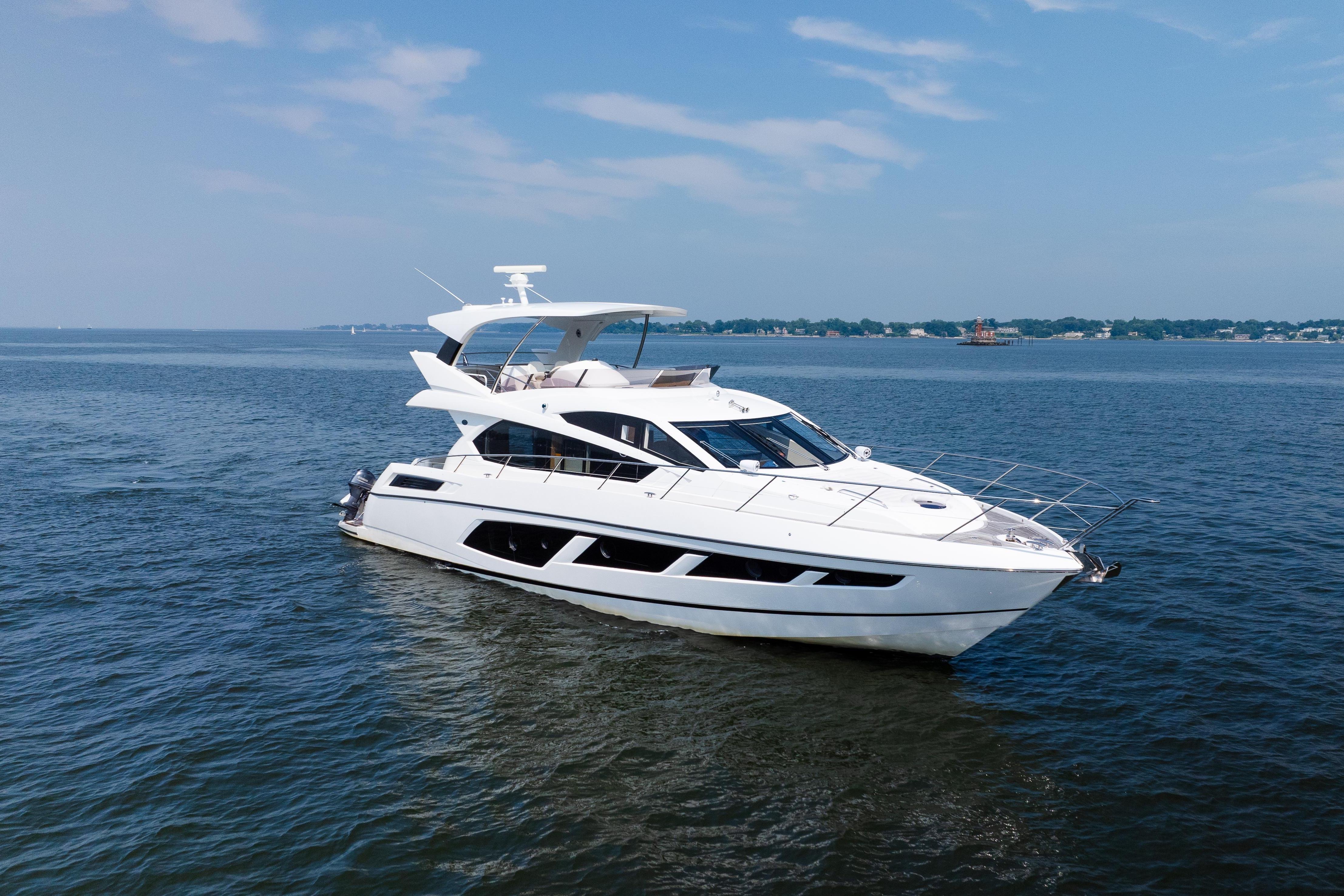 2016 Sunseeker Manhattan 65 yacht cruising on open water under a clear sky.