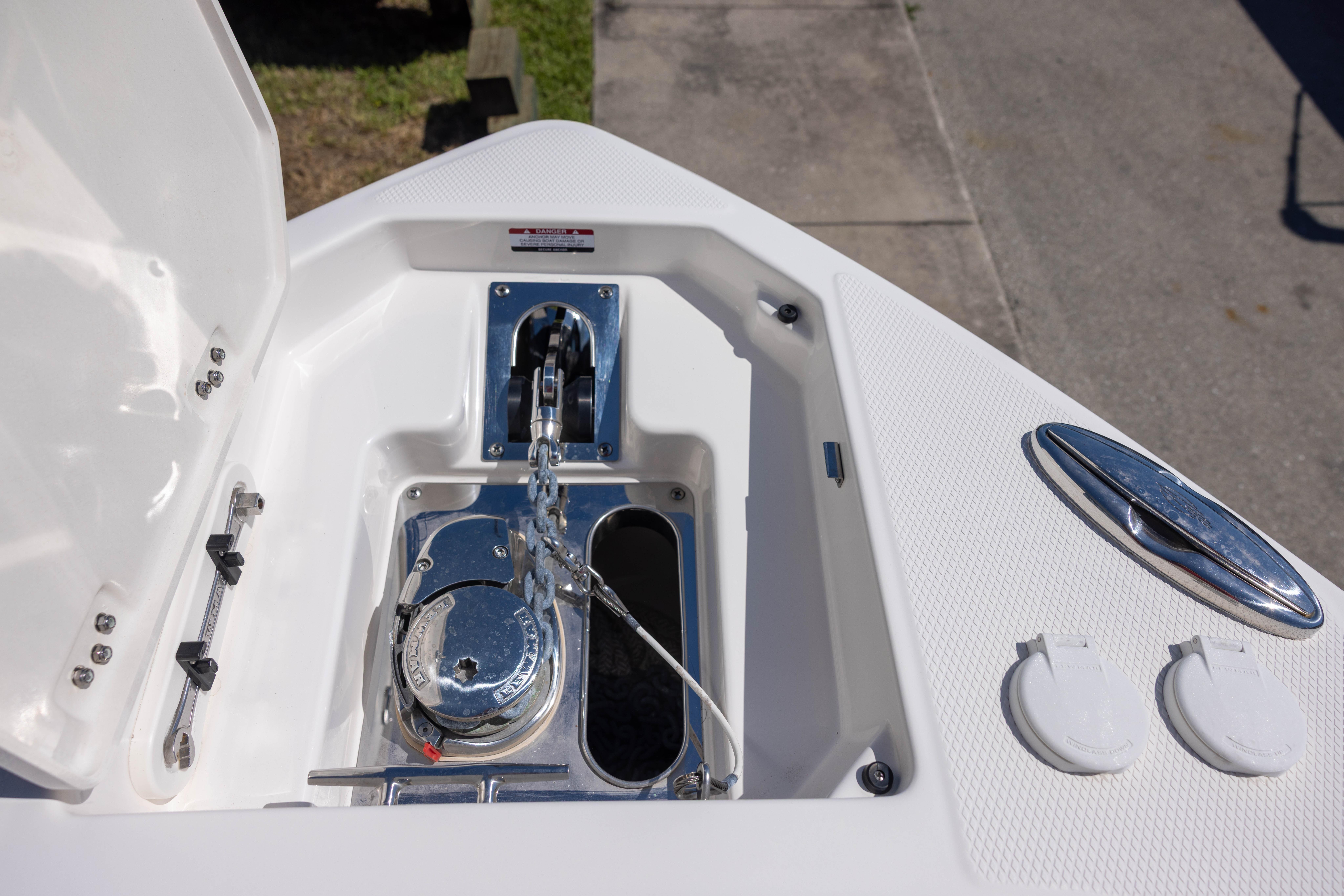 Anchor compartment of 2022 Chaparral 300 OSX boat, featuring a polished winch and chain.