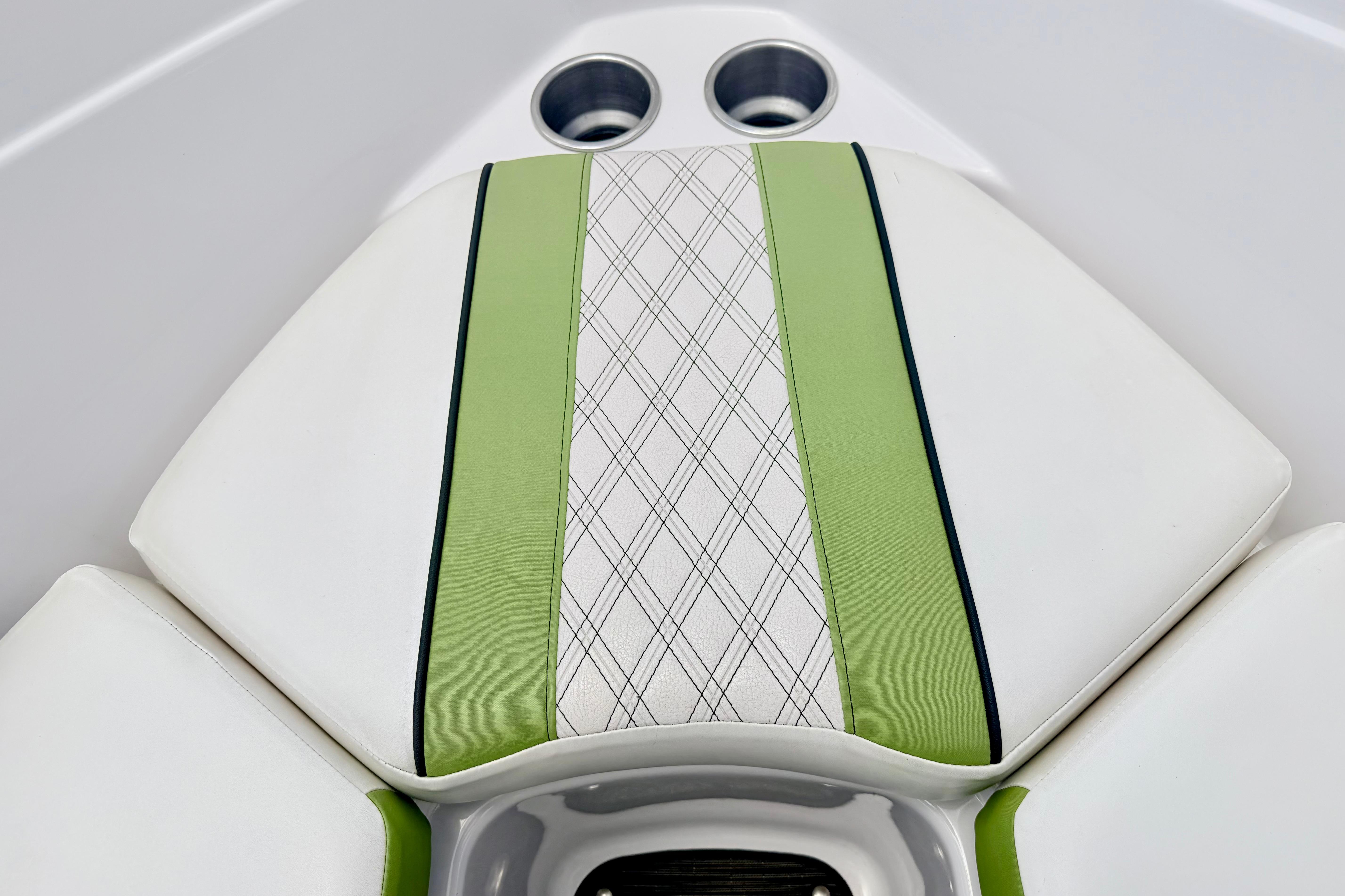 2018 Glastron GT 185 boat interior with green and white cushioned seating.