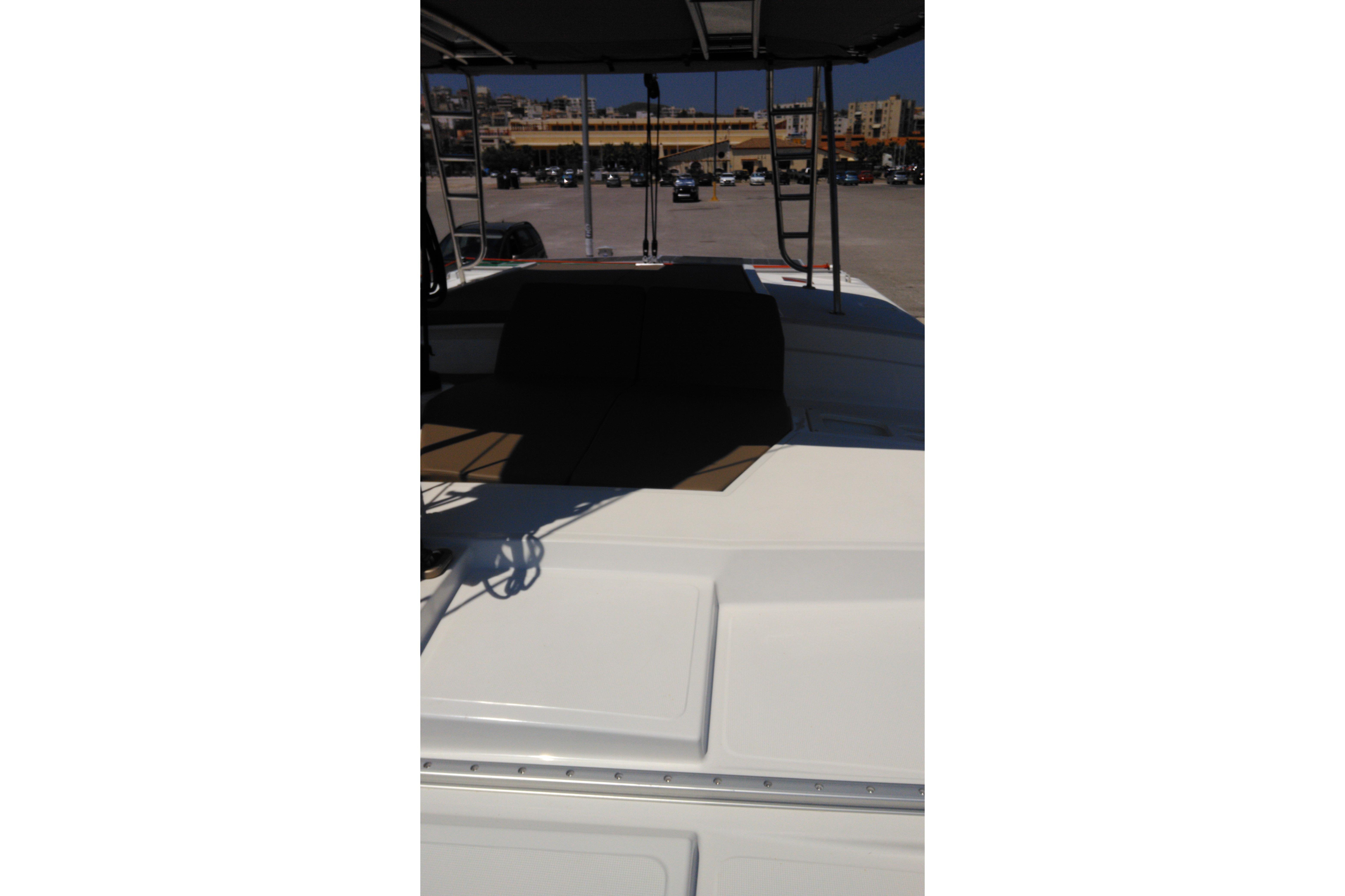 2018 Bali 4.1 catamaran deck with seating area, parked in a marina.