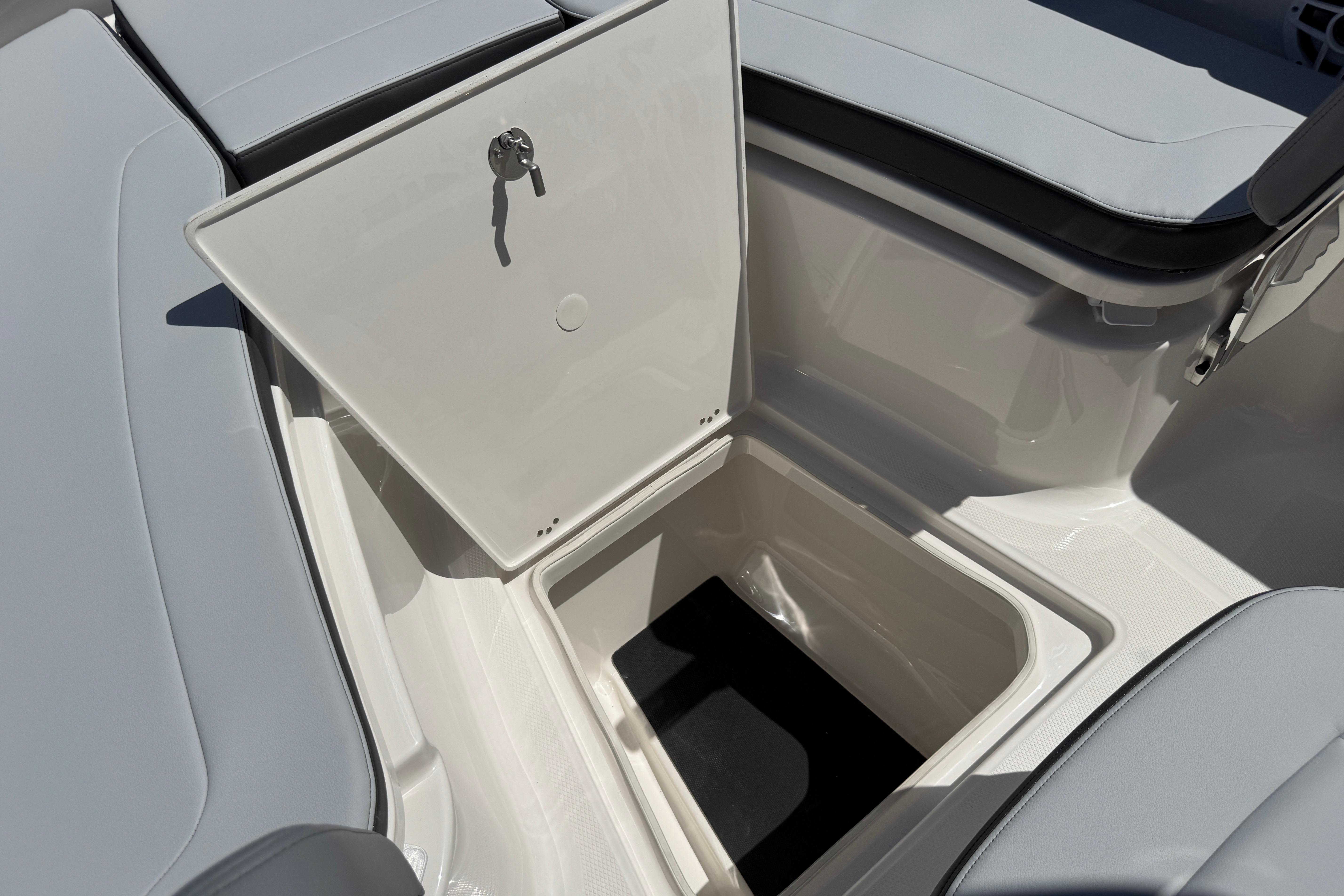 2026 Robalo R250 Center Console boat storage compartment with open hatch.