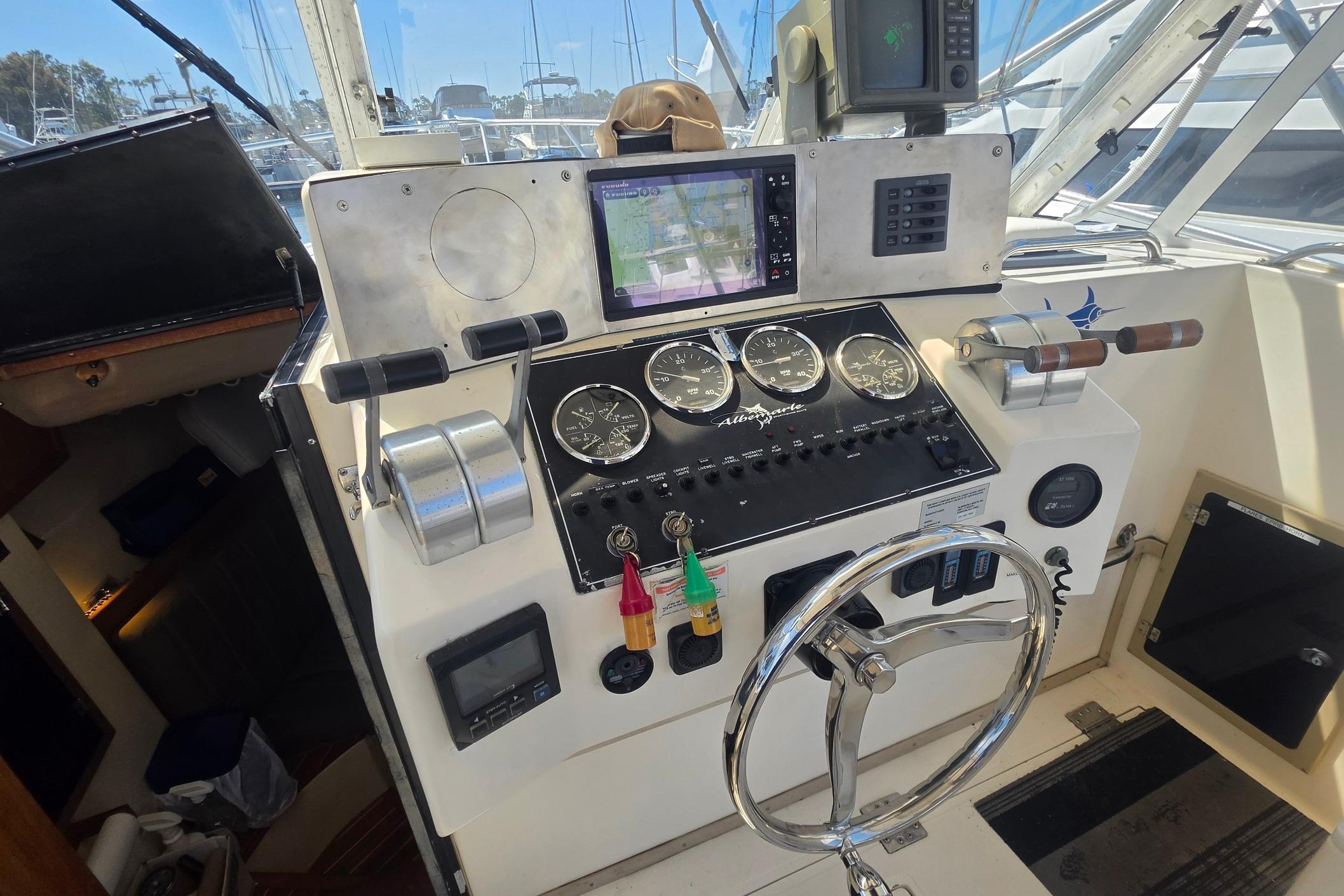 Control panel of a 1999 Albemarle 305 Express Fisherman boat with gauges and navigation equipment.