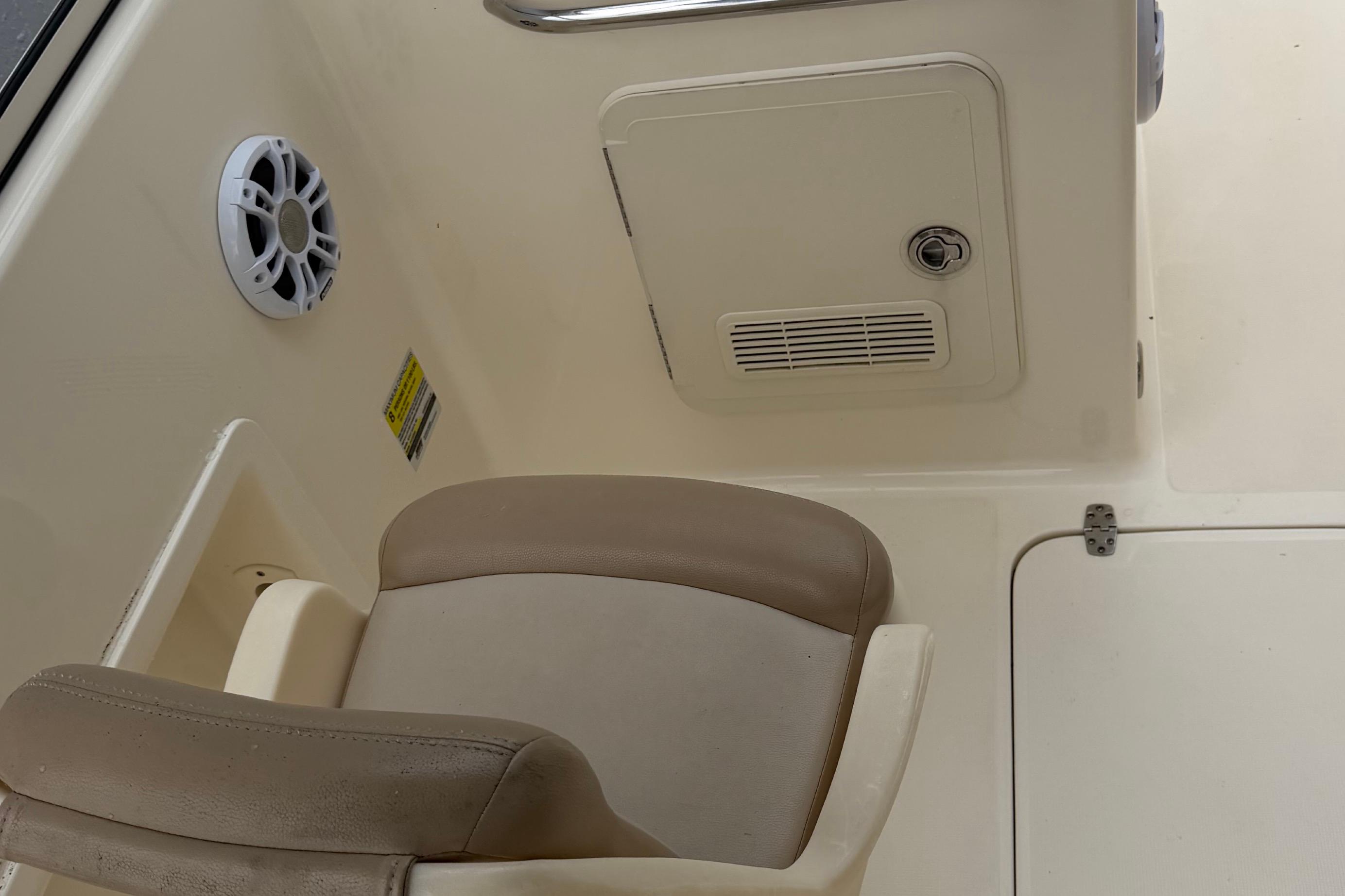 Interior of 2023 Scout 210 Dorado boat with seat and speaker.