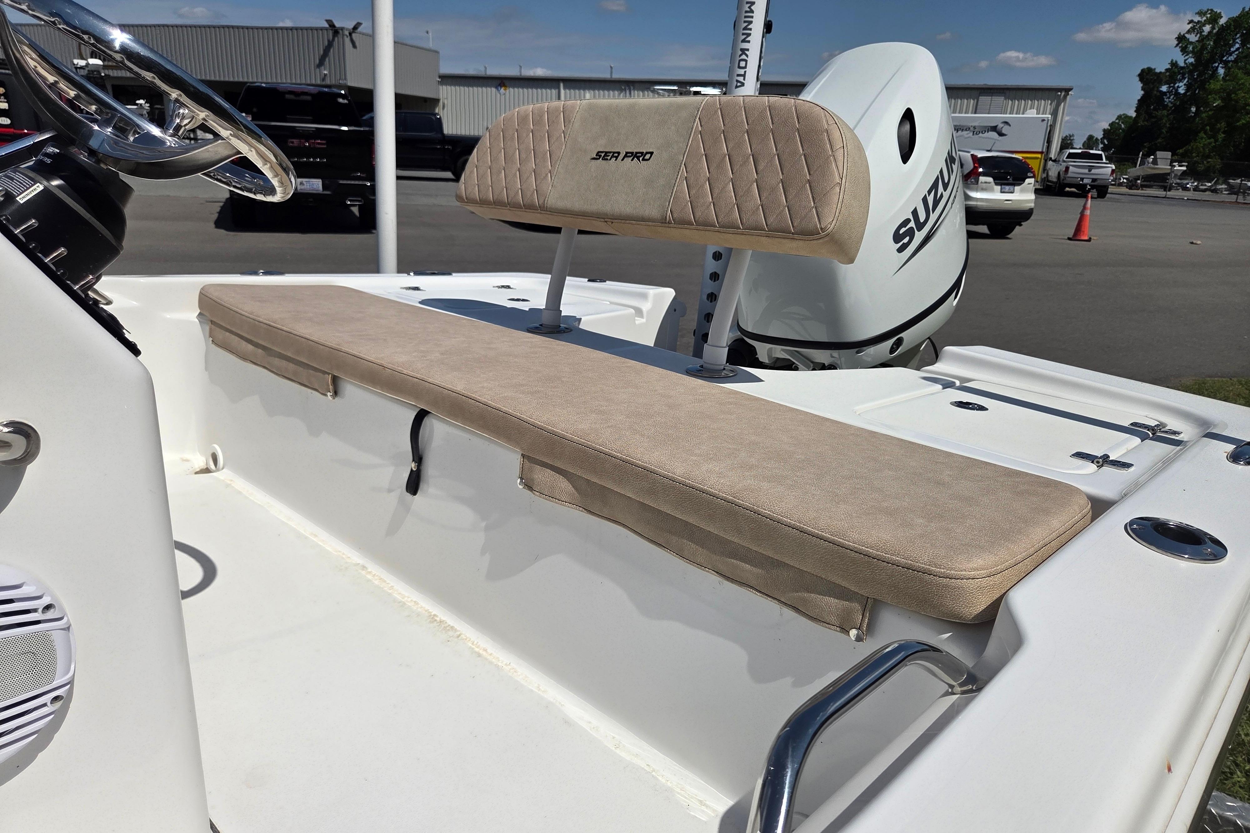 2024 Sea Pro 172 Bay boat interior with beige seating and Suzuki outboard motor.