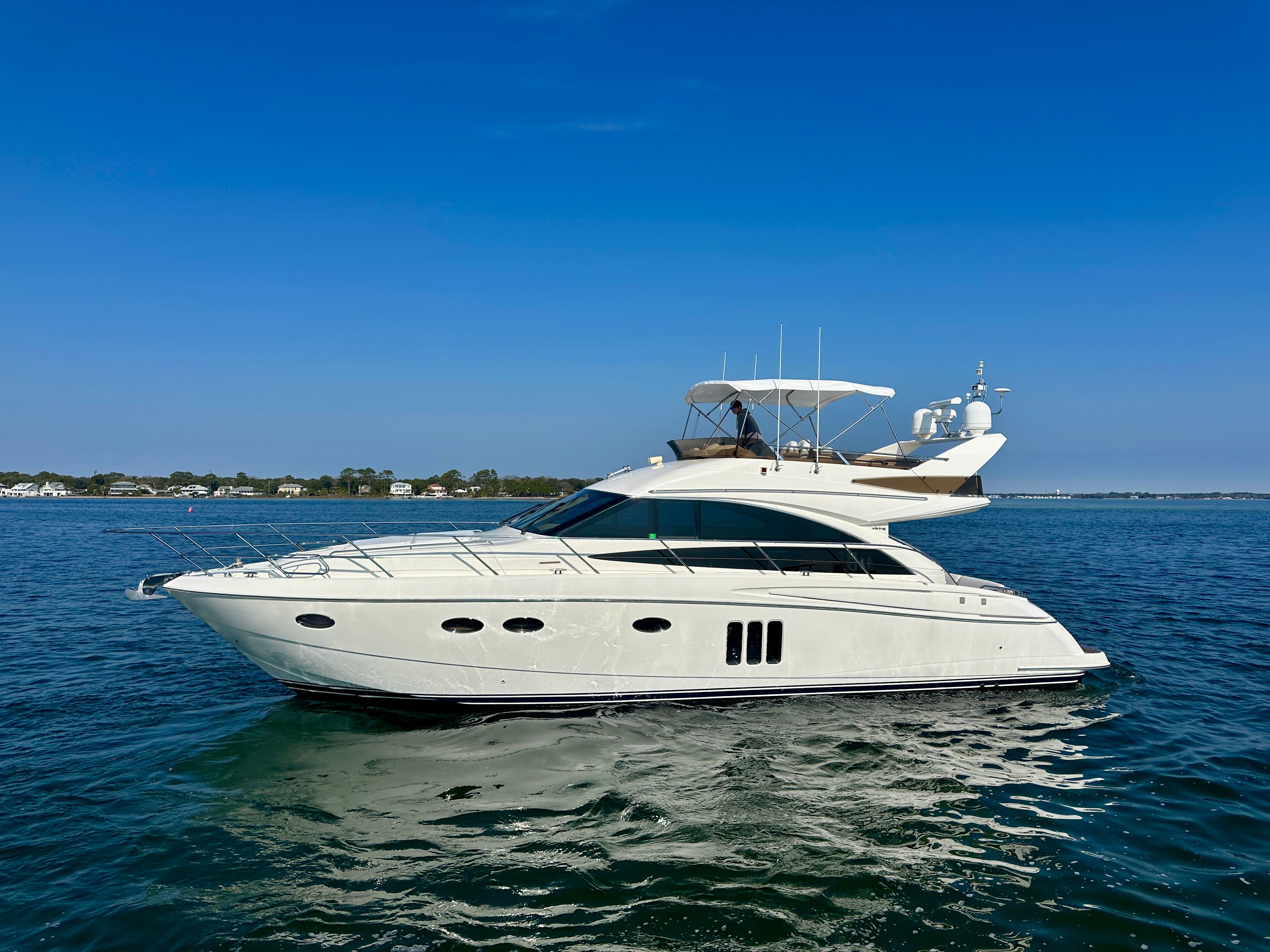 2009 Viking Princess F54 Flybridge yacht on calm waters.