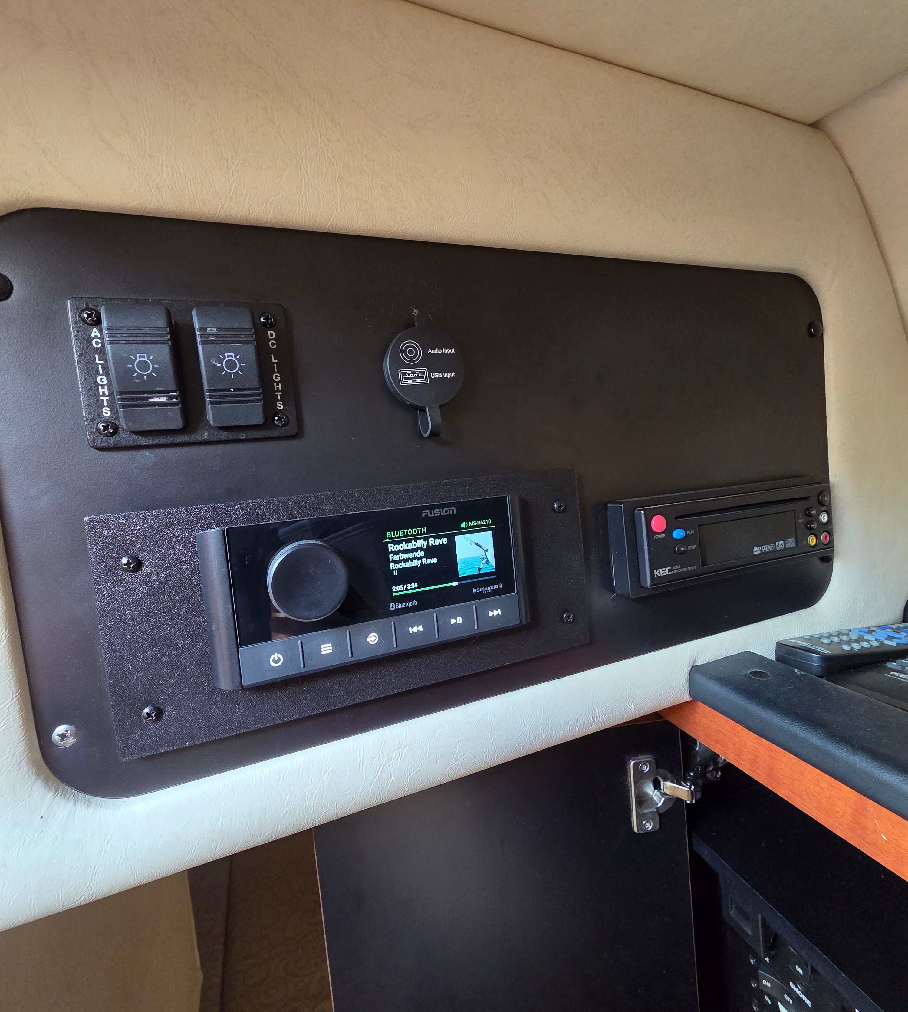 Interior view of a 2005 Sea Ray Sundancer 260 with control panel and entertainment system.
