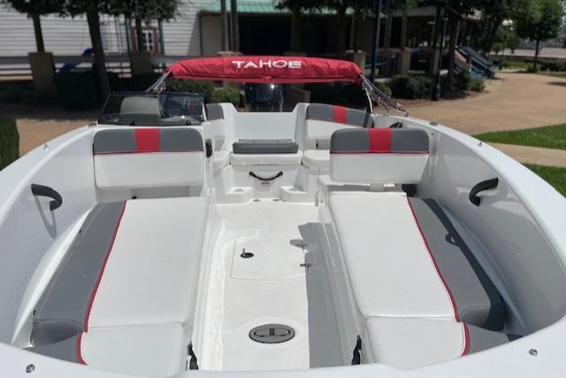 2024 Tahoe T18 boat interior with red and gray seating, showcasing spacious design.