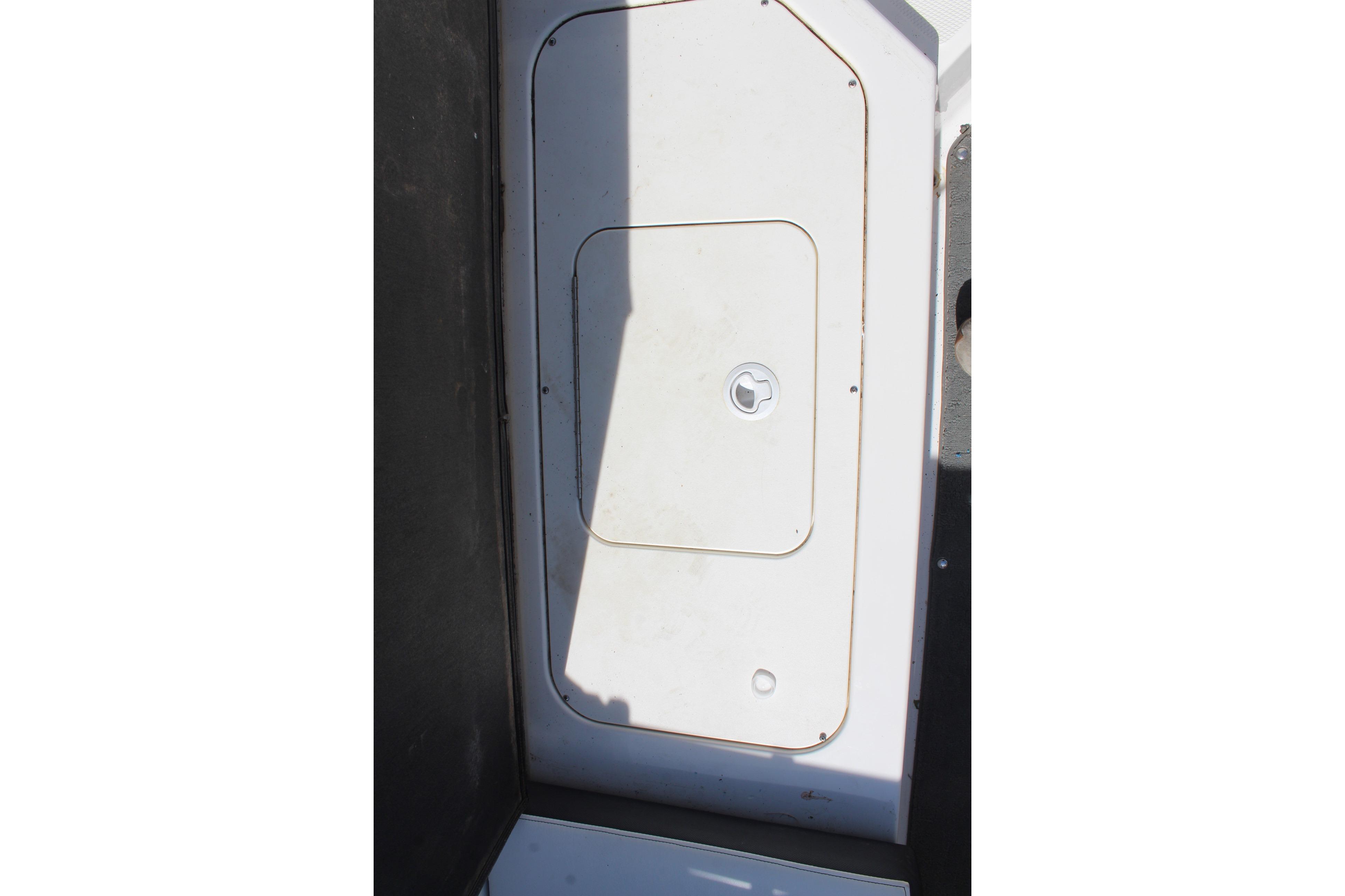2015 Sea Ray 19 SPX OB boat storage compartment with latch, viewed from above.