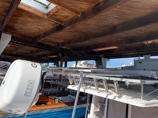 2021 Cutwater C-32 CB boat under wooden dock roof with radar equipment.