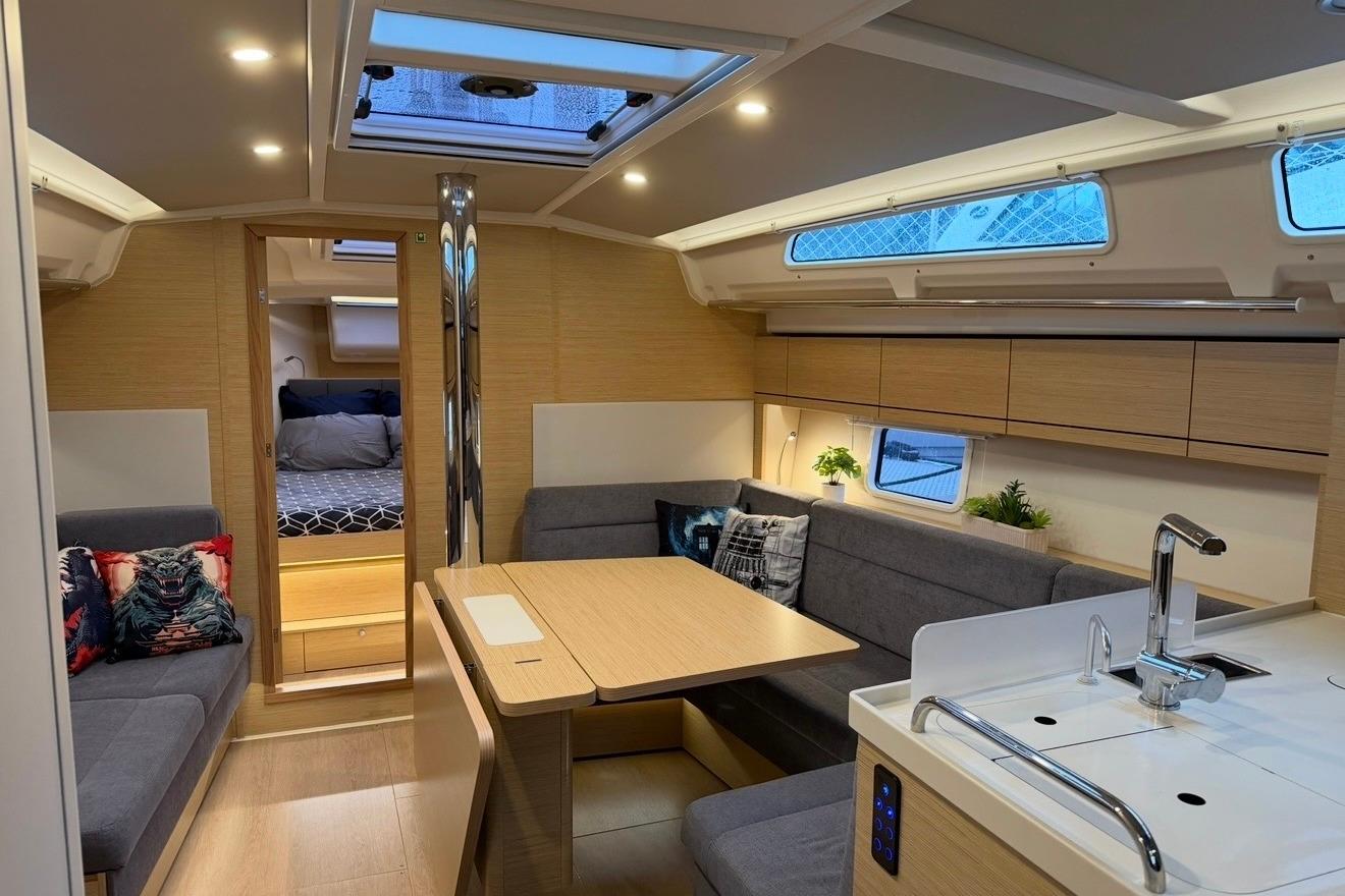 Modern interior of 2022 Hanse 418 yacht with cozy seating and elegant design.