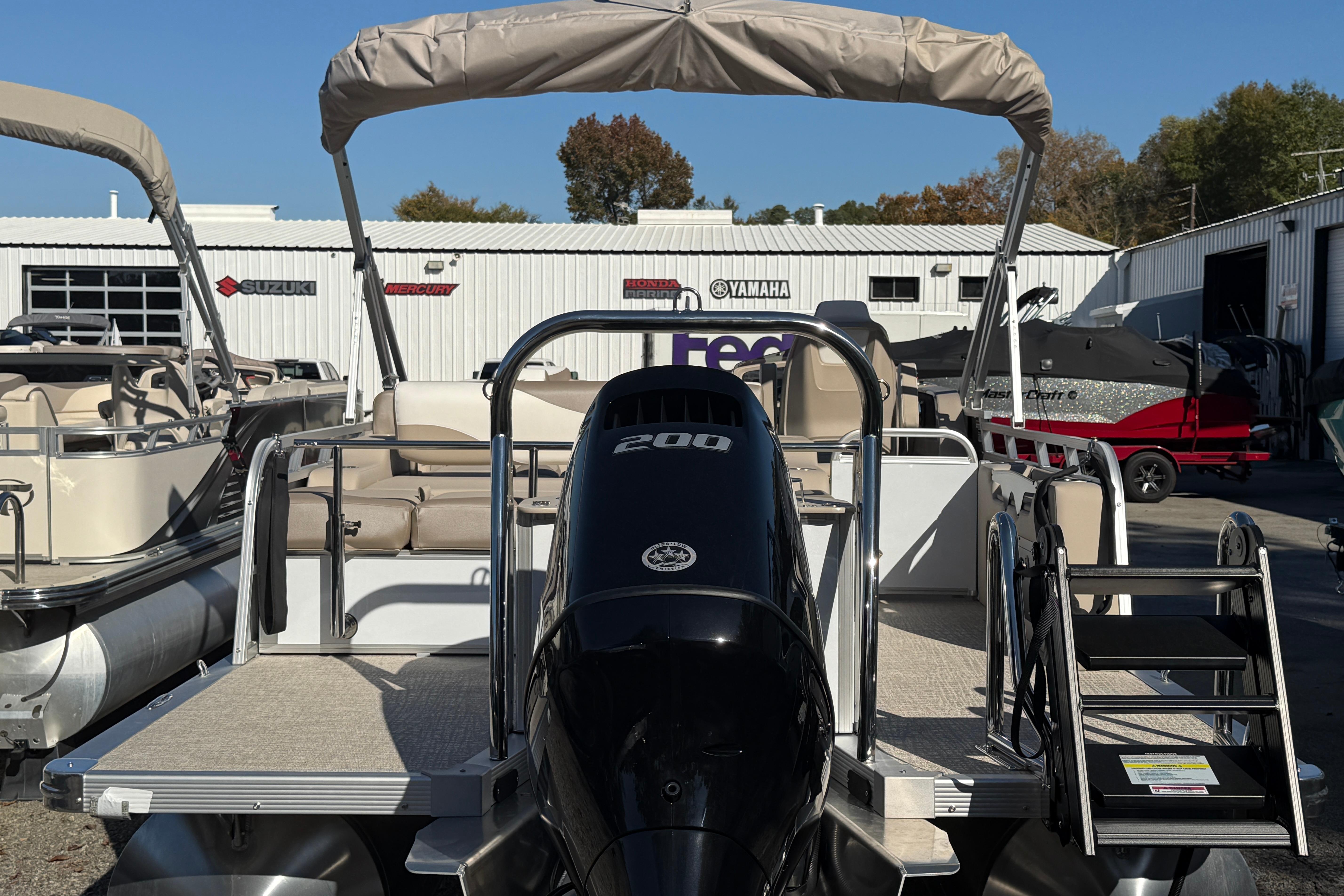 2026 Tahoe Pontoon LTZ Versatile Rear Lounger with powerful 200 HP engine, docked outdoors.