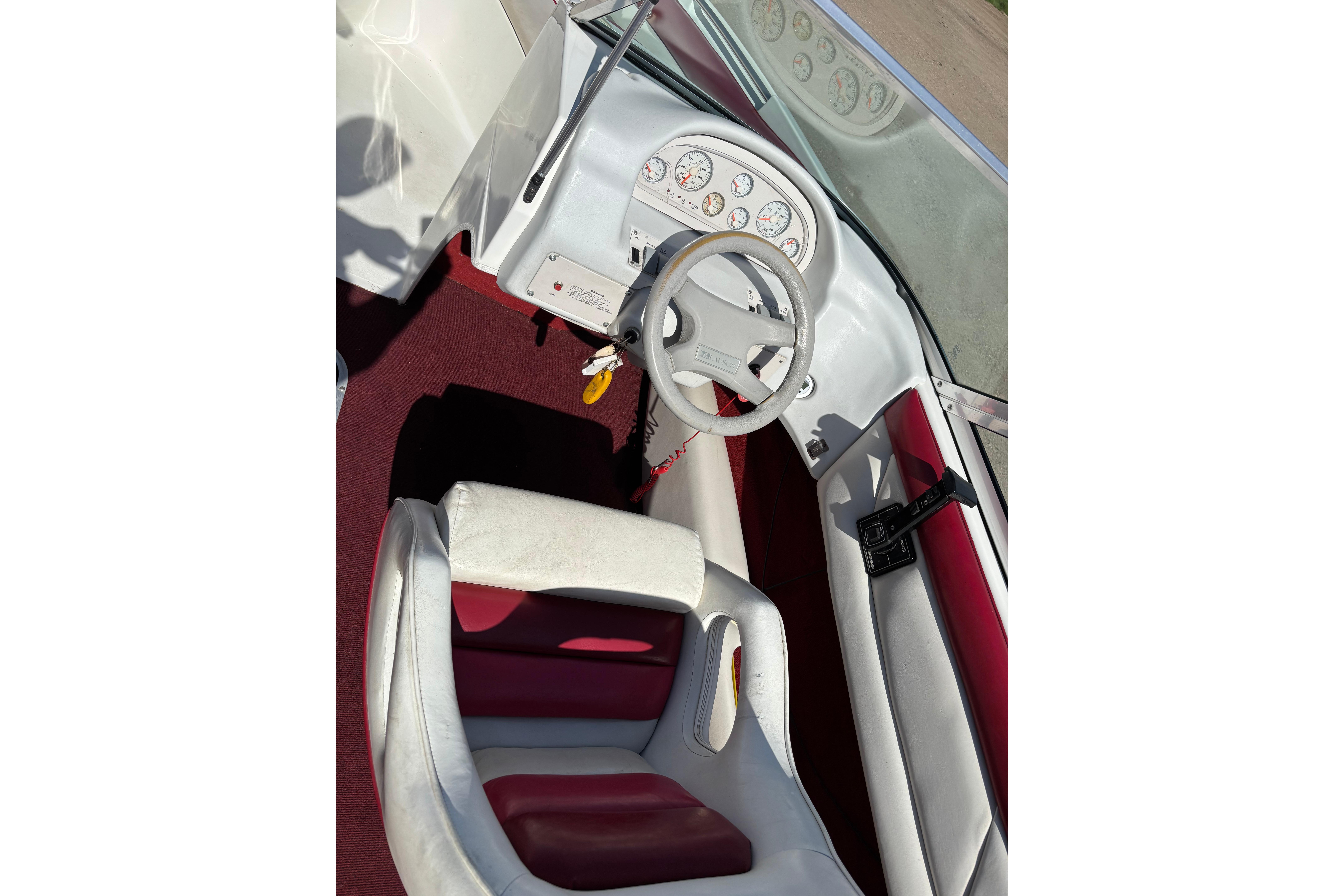 Interior of a 1993 Larson SEi 200 Cuddy I/O boat with red and white seating.