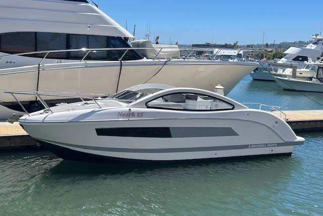 2024 Bracewell 25 yacht docked in marina, sleek design, sunny day.