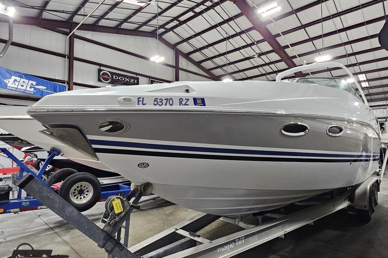 2008 Baja 335 Performance boat on trailer in indoor showroom.