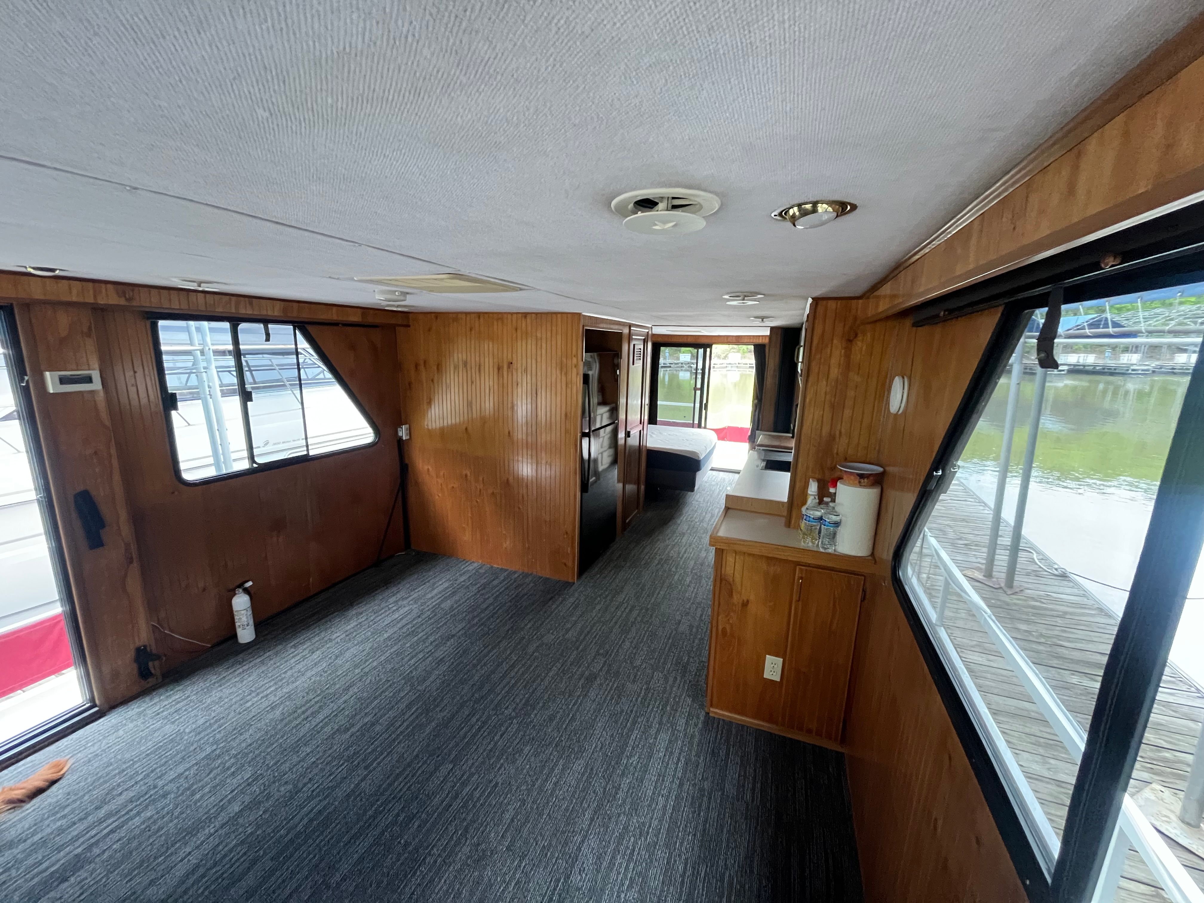Interior of a 1995 Gibson Executive with wood paneling and carpet, view of the dock.