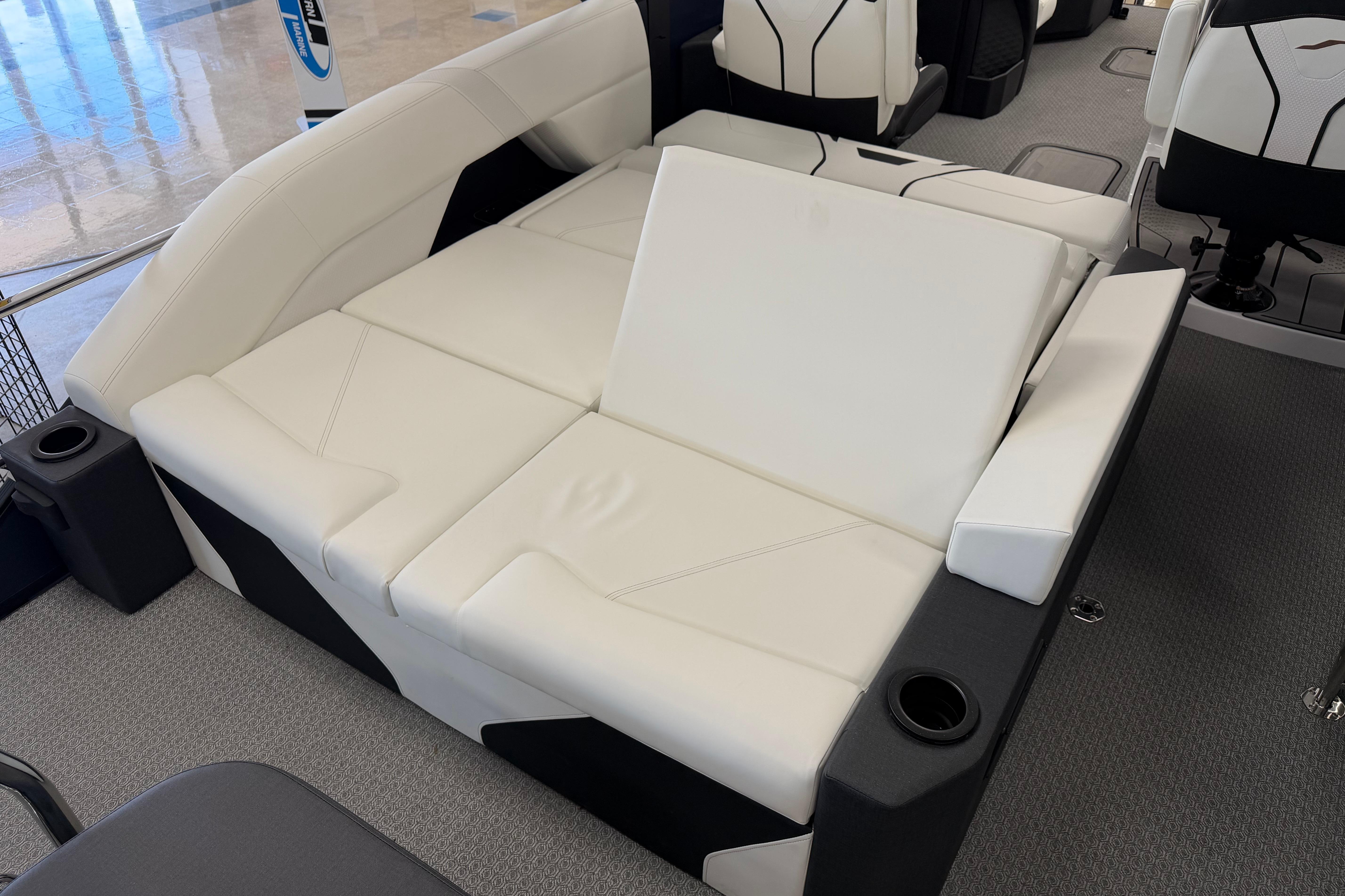 Luxurious white seating in 2026 Evotti 721CS boat interior, featuring cup holders and modern design.