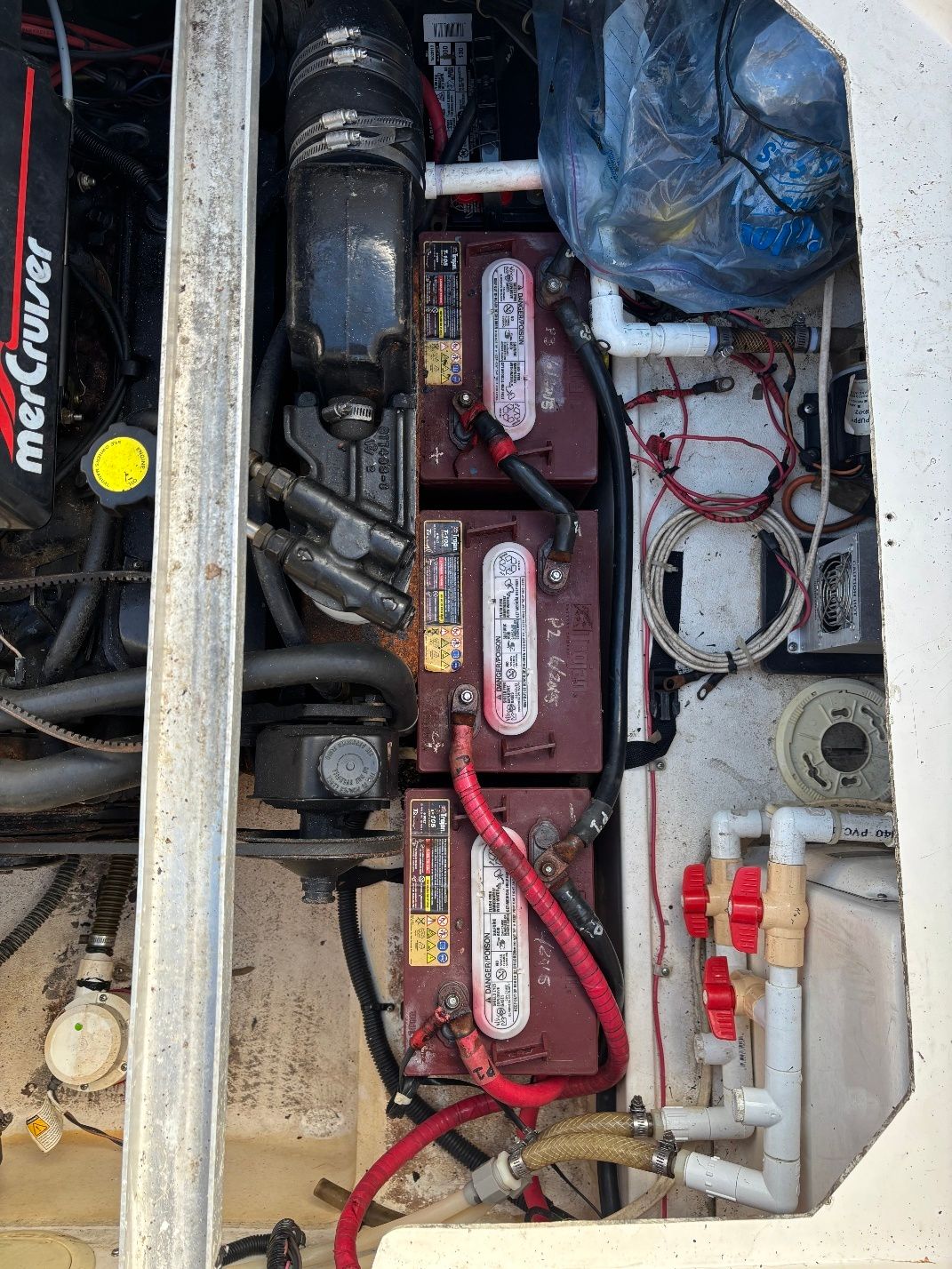 Engine compartment of a 1997 Donzi 275LXC with batteries and wiring.