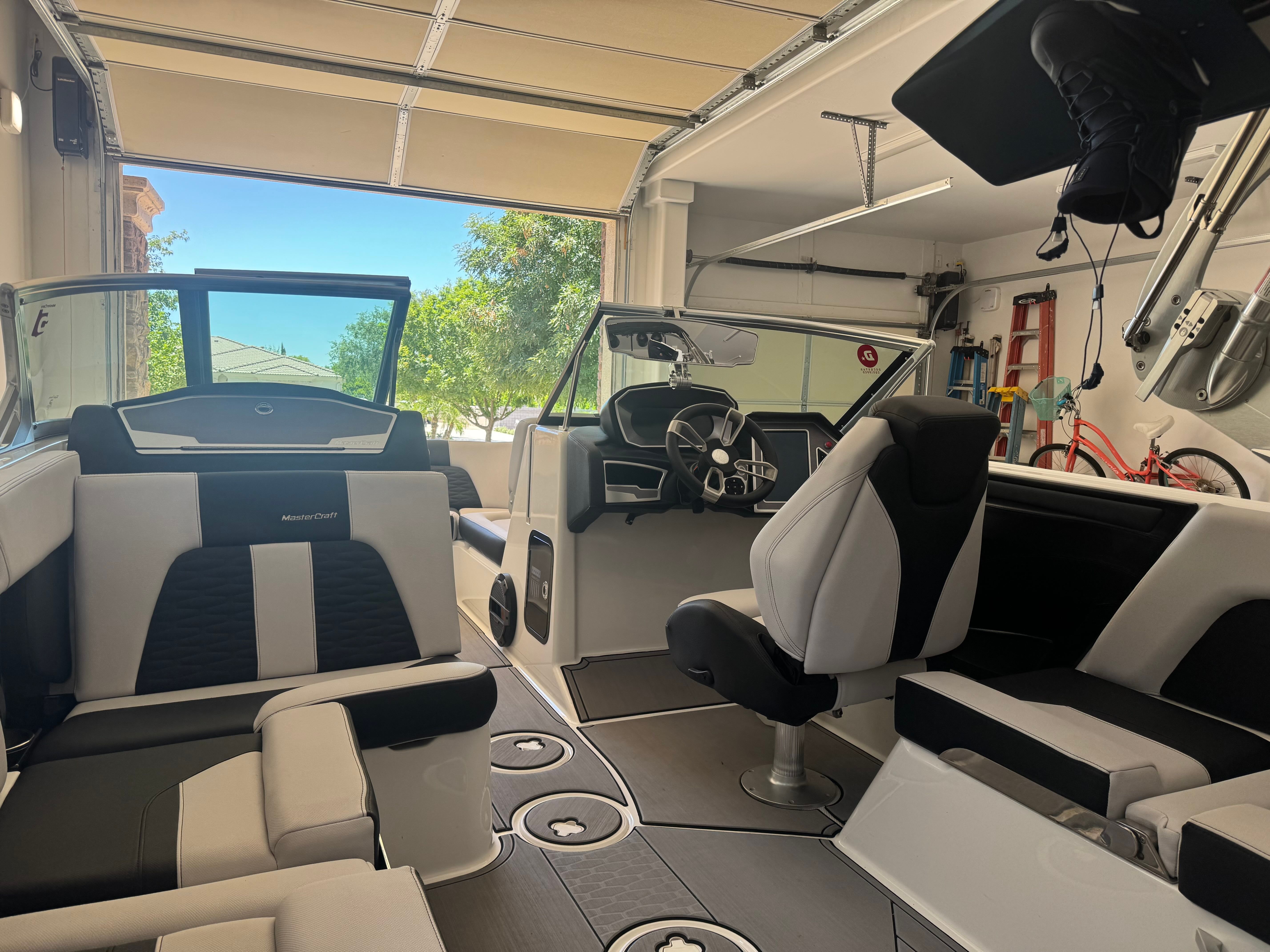 Interior of a 2020 MasterCraft X24 boat in a garage.