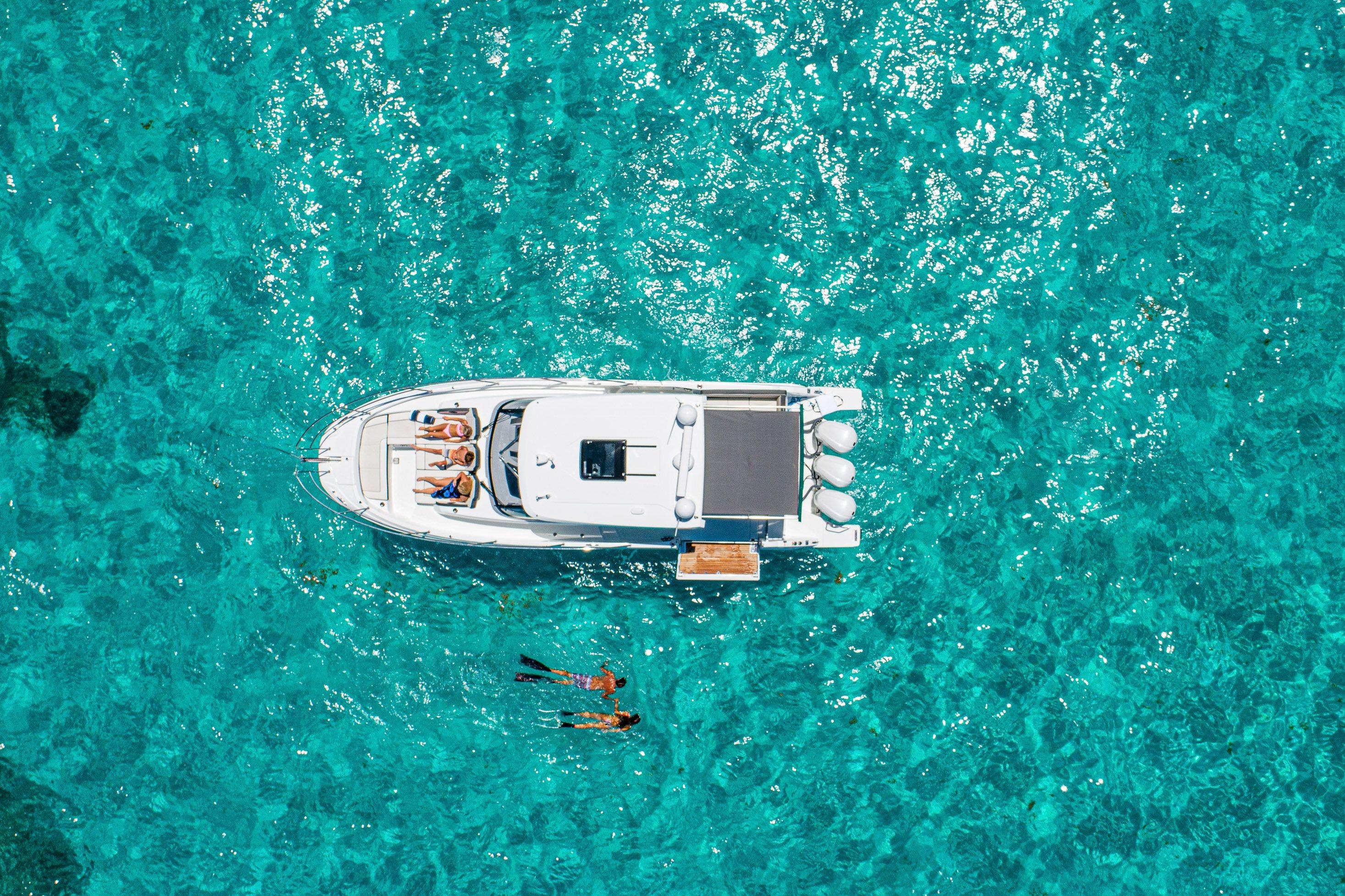Aerial view of 2026 Jeanneau Leader 12.5 WA yacht on clear turquoise water.