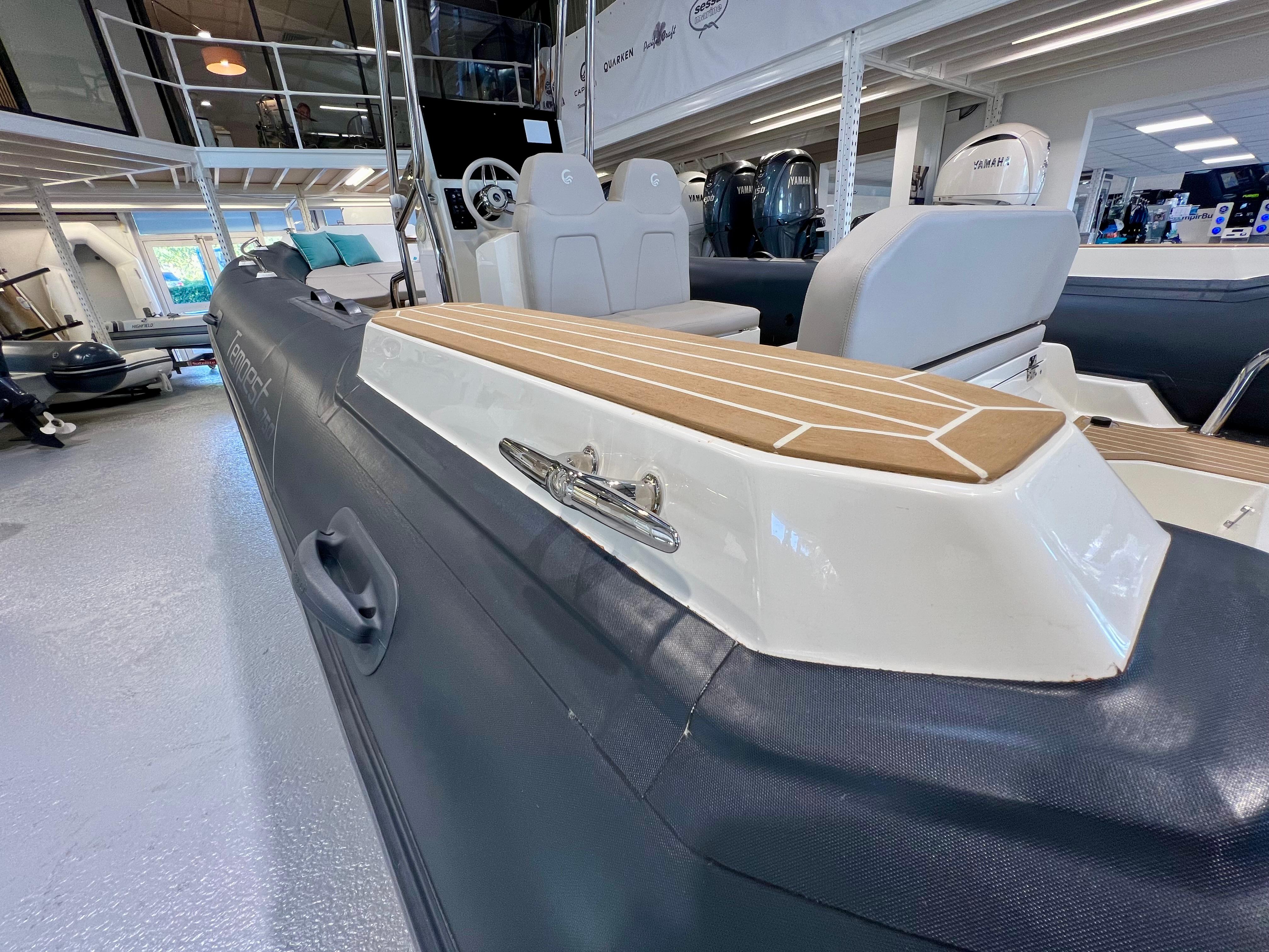 2023 Capelli Tempest 750 Luxe boat interior, showcasing seating and deck details in showroom.