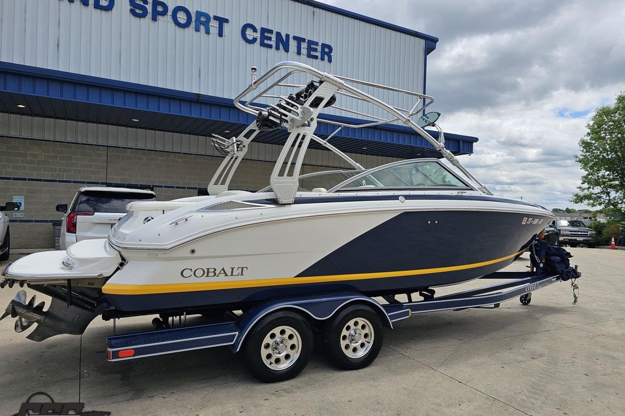 2010 Cobalt 232 WSS boat on trailer outside a sports center.
