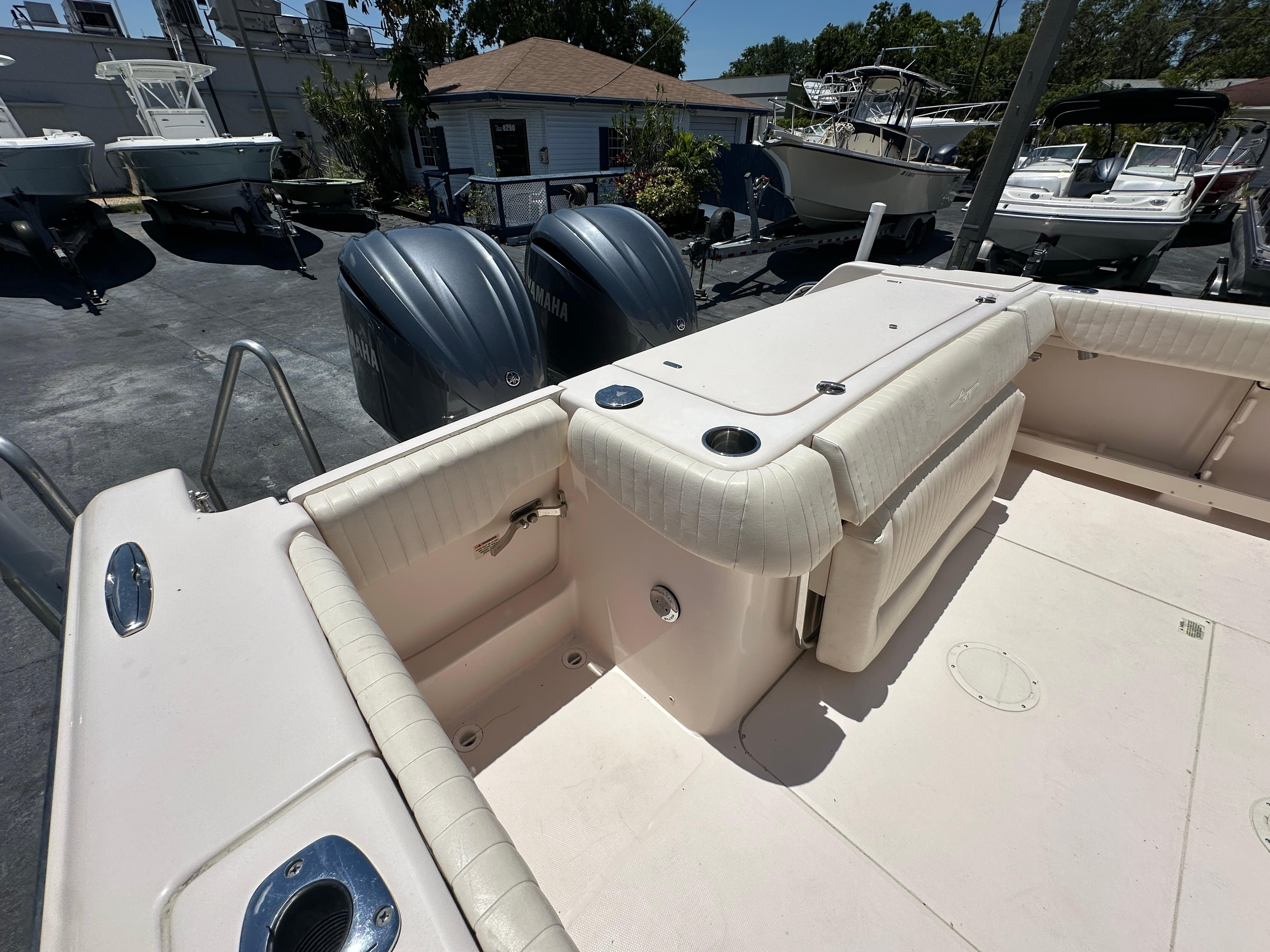 2013 Grady-White Canyon 306 boat interior with dual outboard motors in a marina setting.