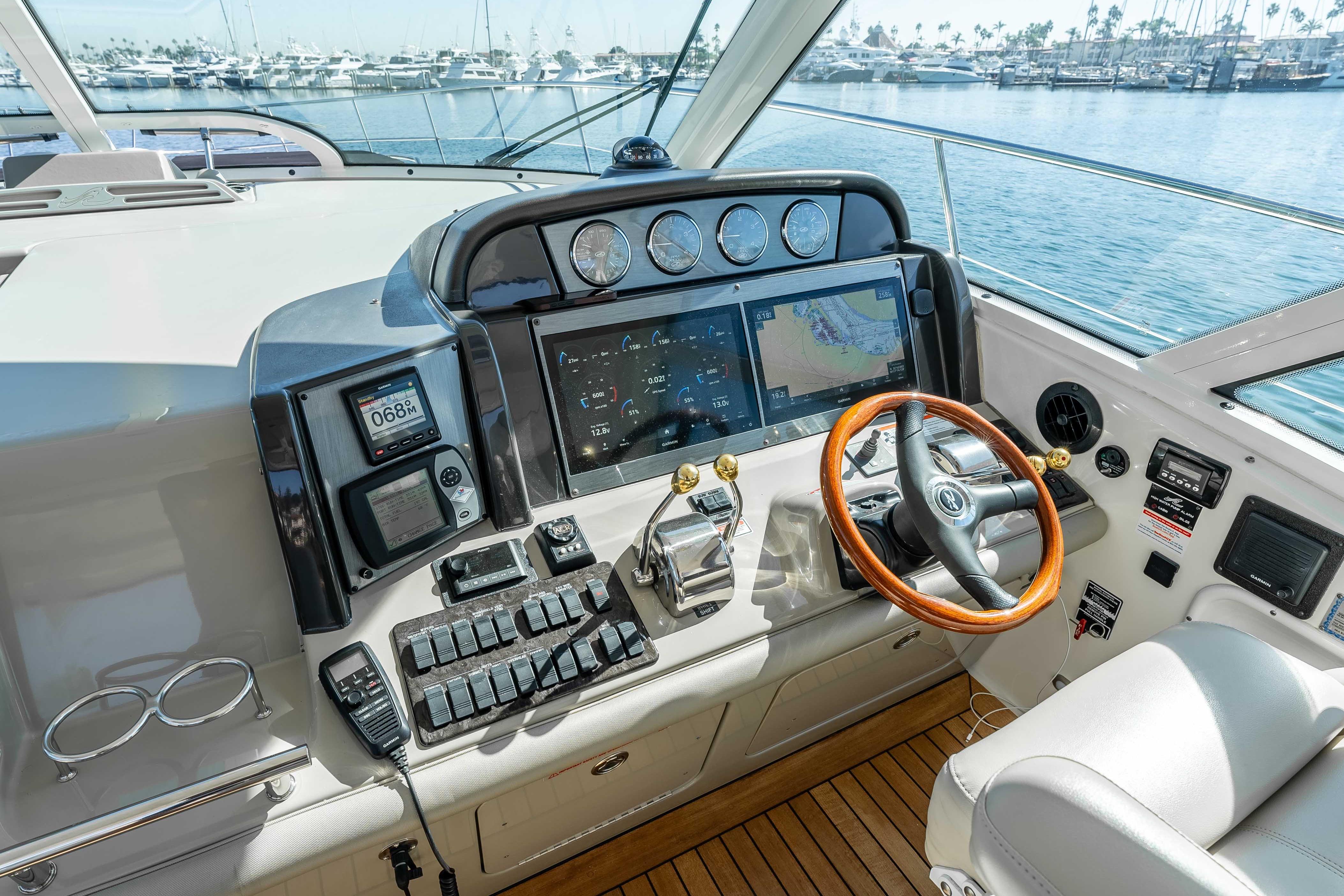 2007 Sea Ray 48 Sundancer helm with advanced navigation and control systems, overlooking marina.