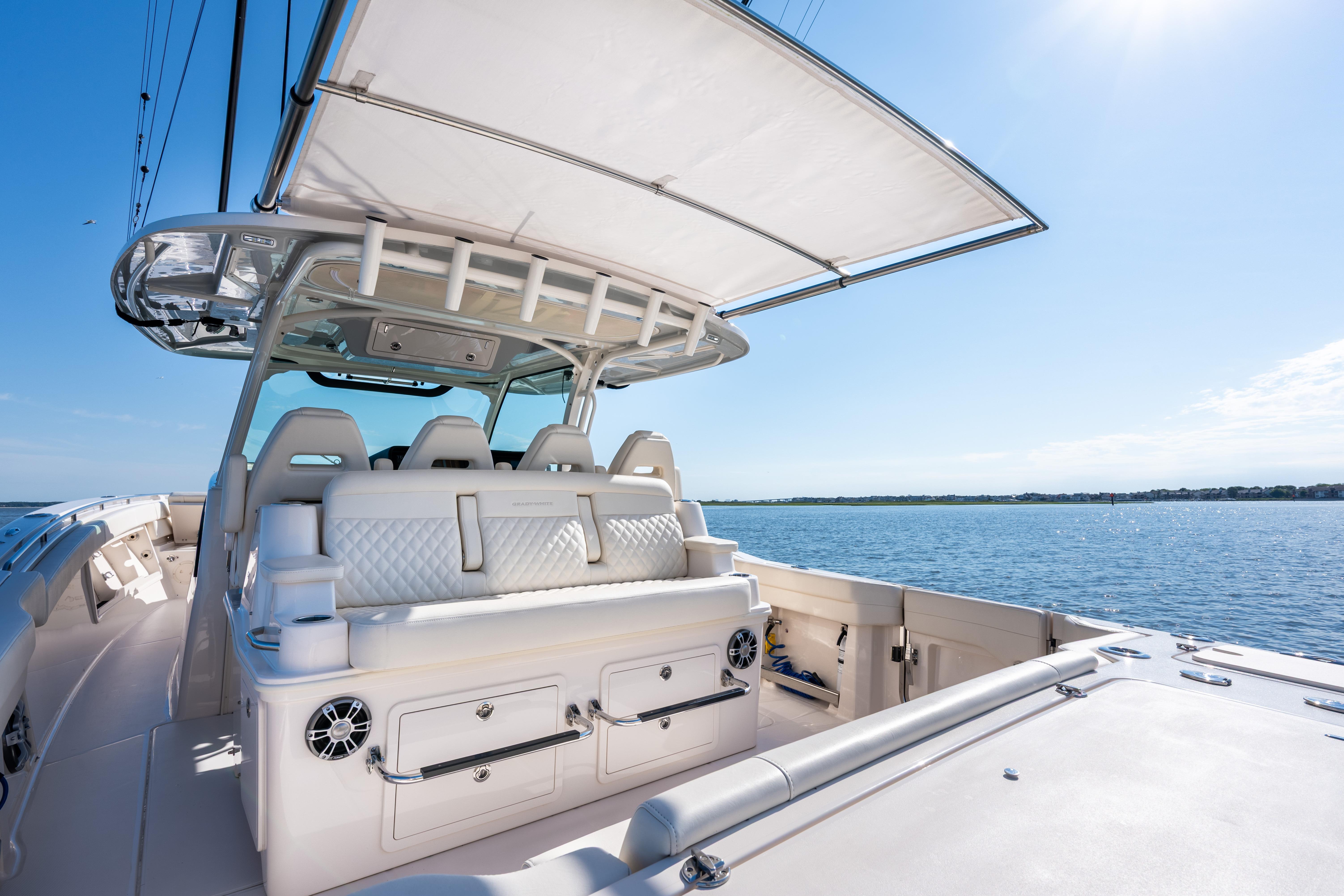 2025 Grady-White Canyon 386 boat interior with seating, under a clear blue sky.