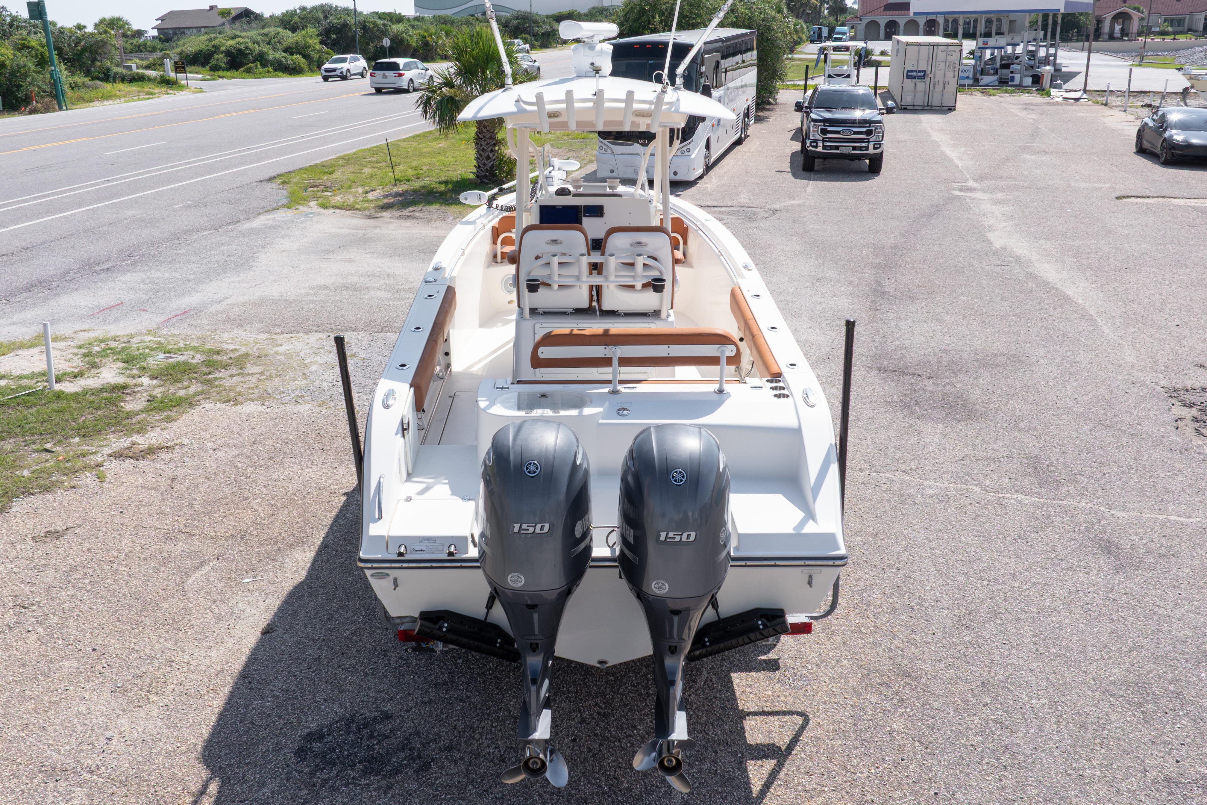 2017 Cobia 261 Center Console boat with dual Yamaha 150 engines, parked on a lot.