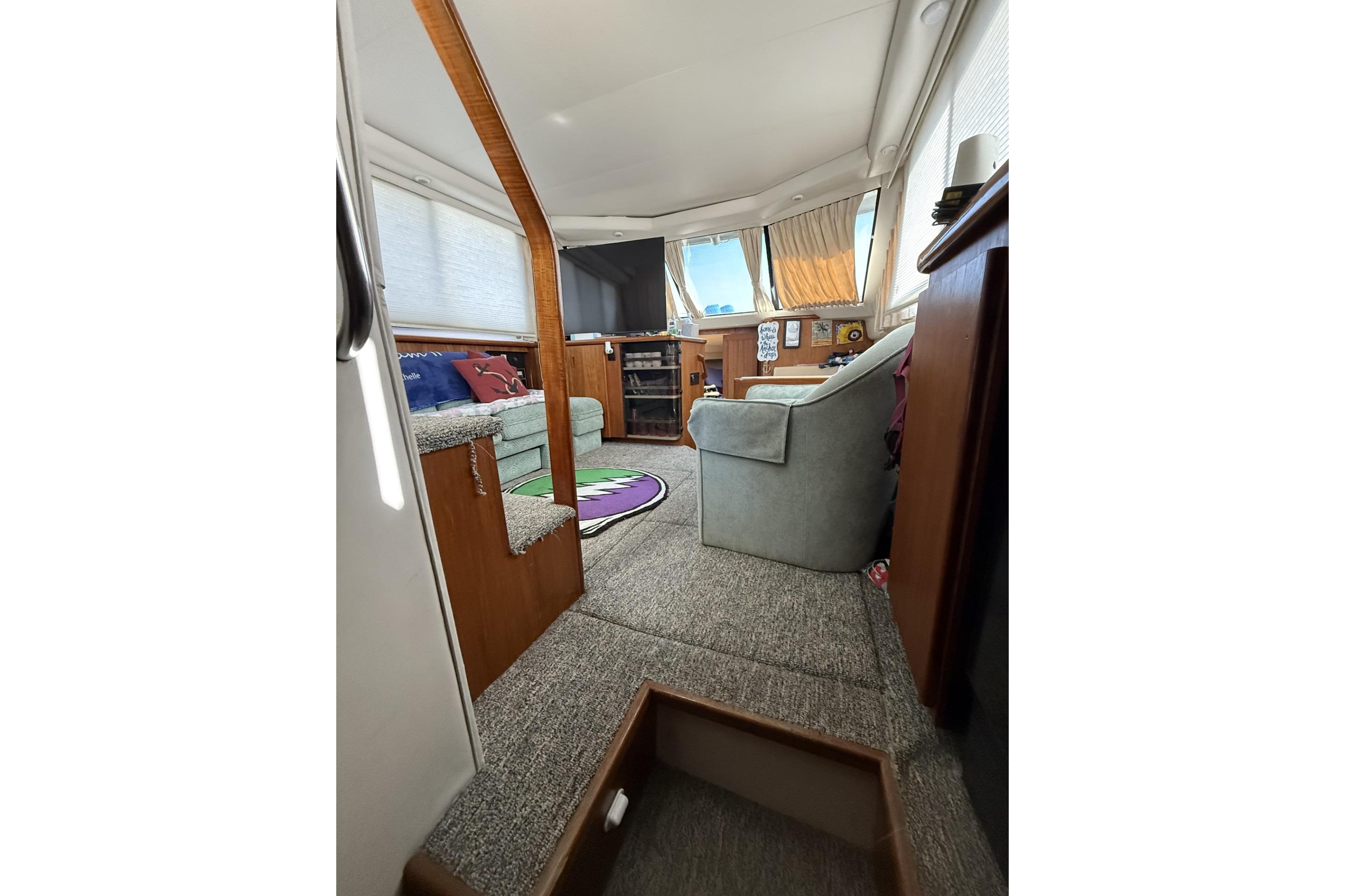 Interior of 1993 Carver 350 Motor Yacht with cozy seating and carpeted flooring.