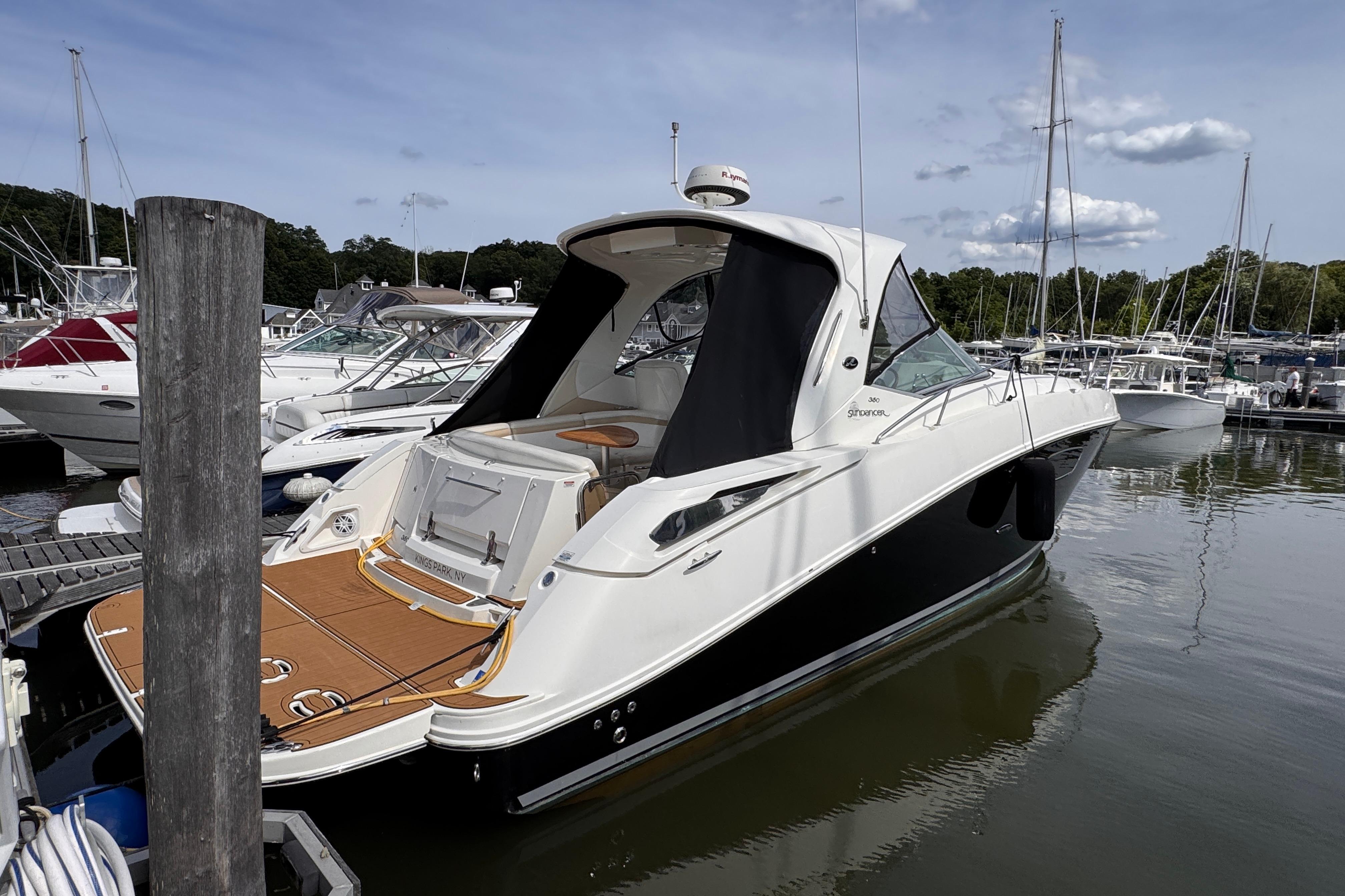 2008 Sea Ray Sundancer 350 yacht docked at marina, featuring sleek design and spacious deck.
