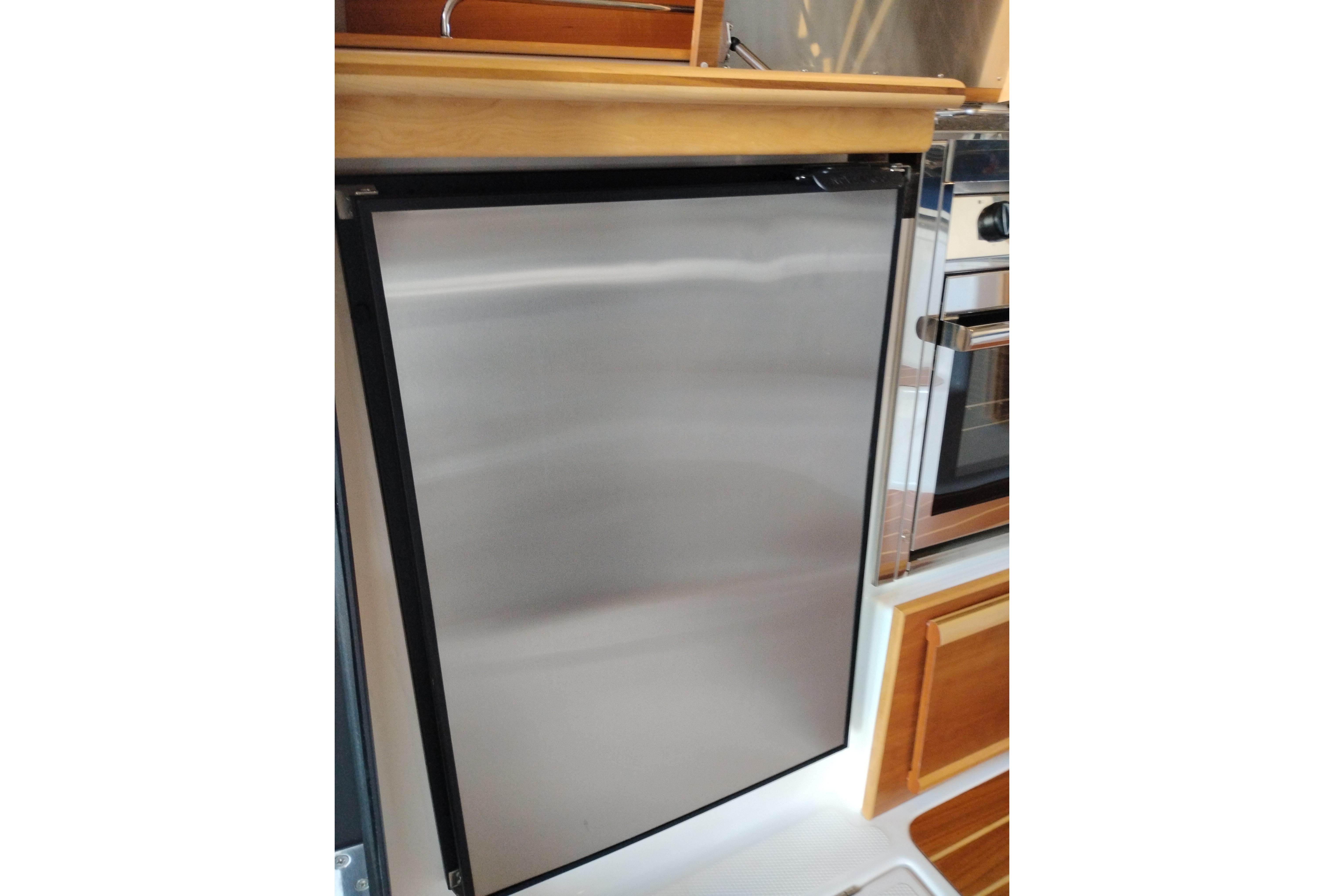 Stainless steel refrigerator in 2022 Cutwater C-32 Coupe yacht kitchen.