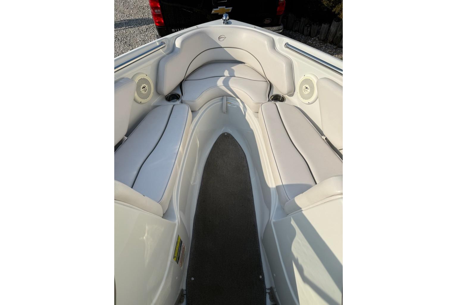 Interior view of a 2012 195 SS boat with white seating and speakers.