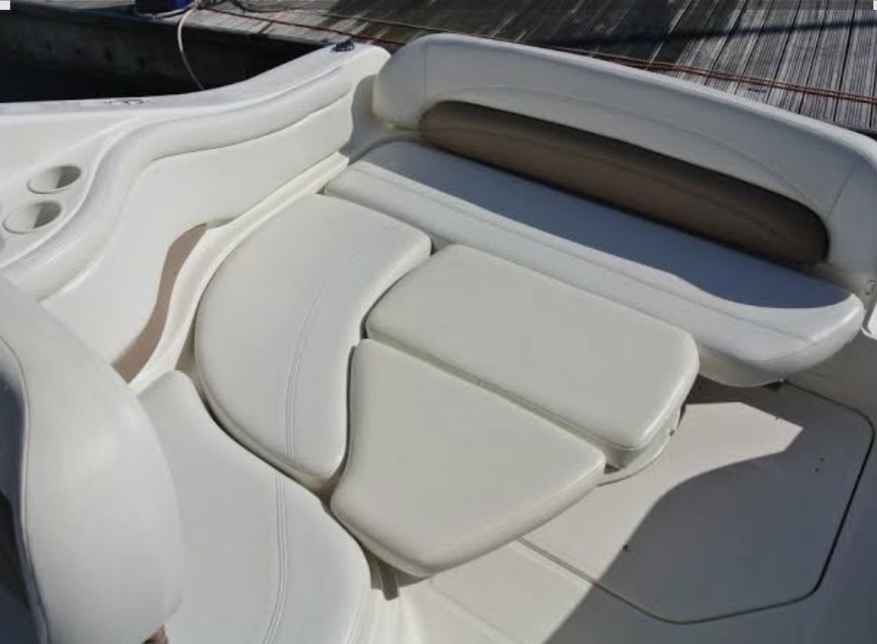 Interior of 2004 Regal Commodore 2465 boat with white leather seating.