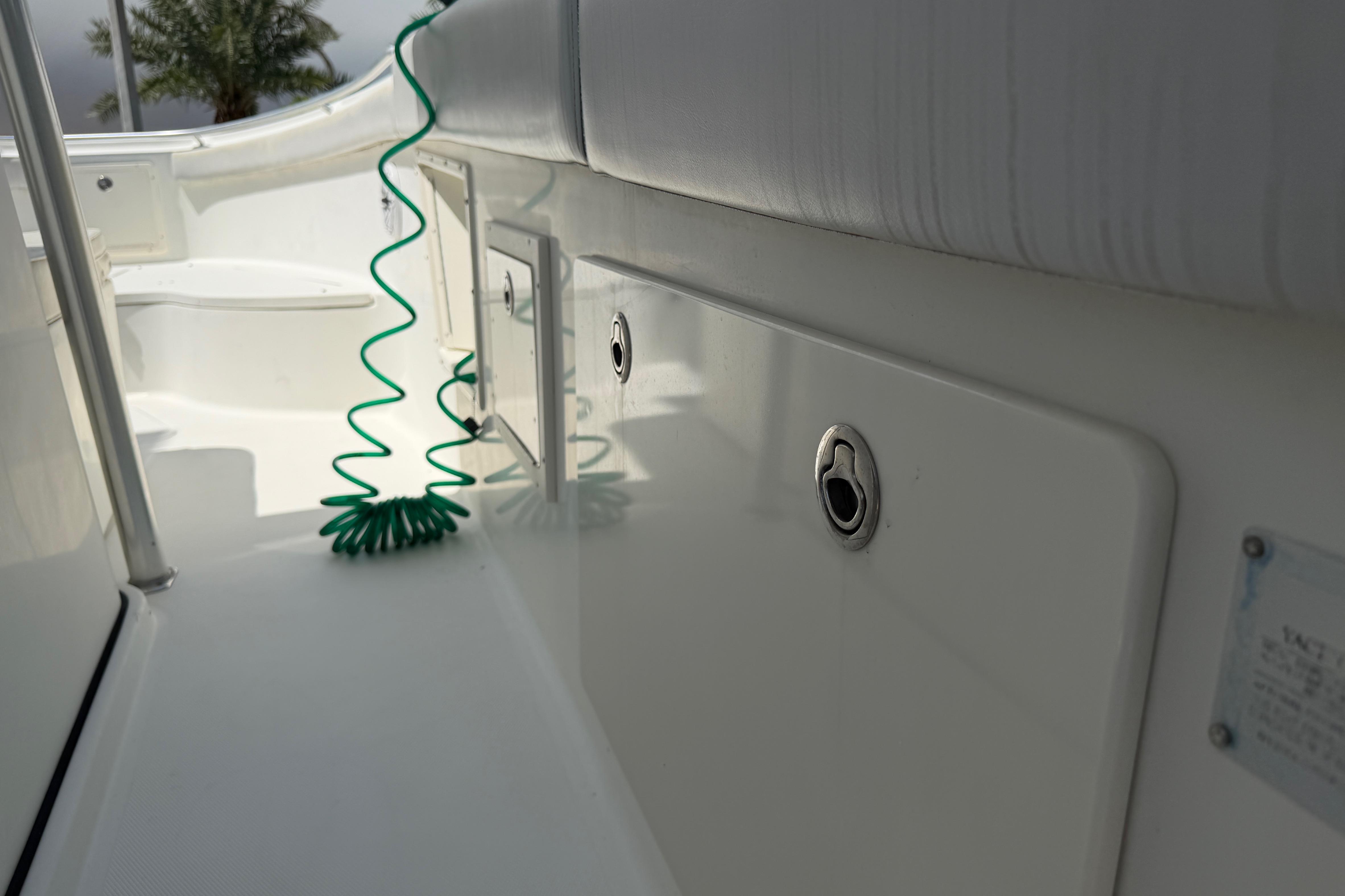 2008 Hydra-Sports Vector 2900 CC boat interior with coiled green hose and seating.