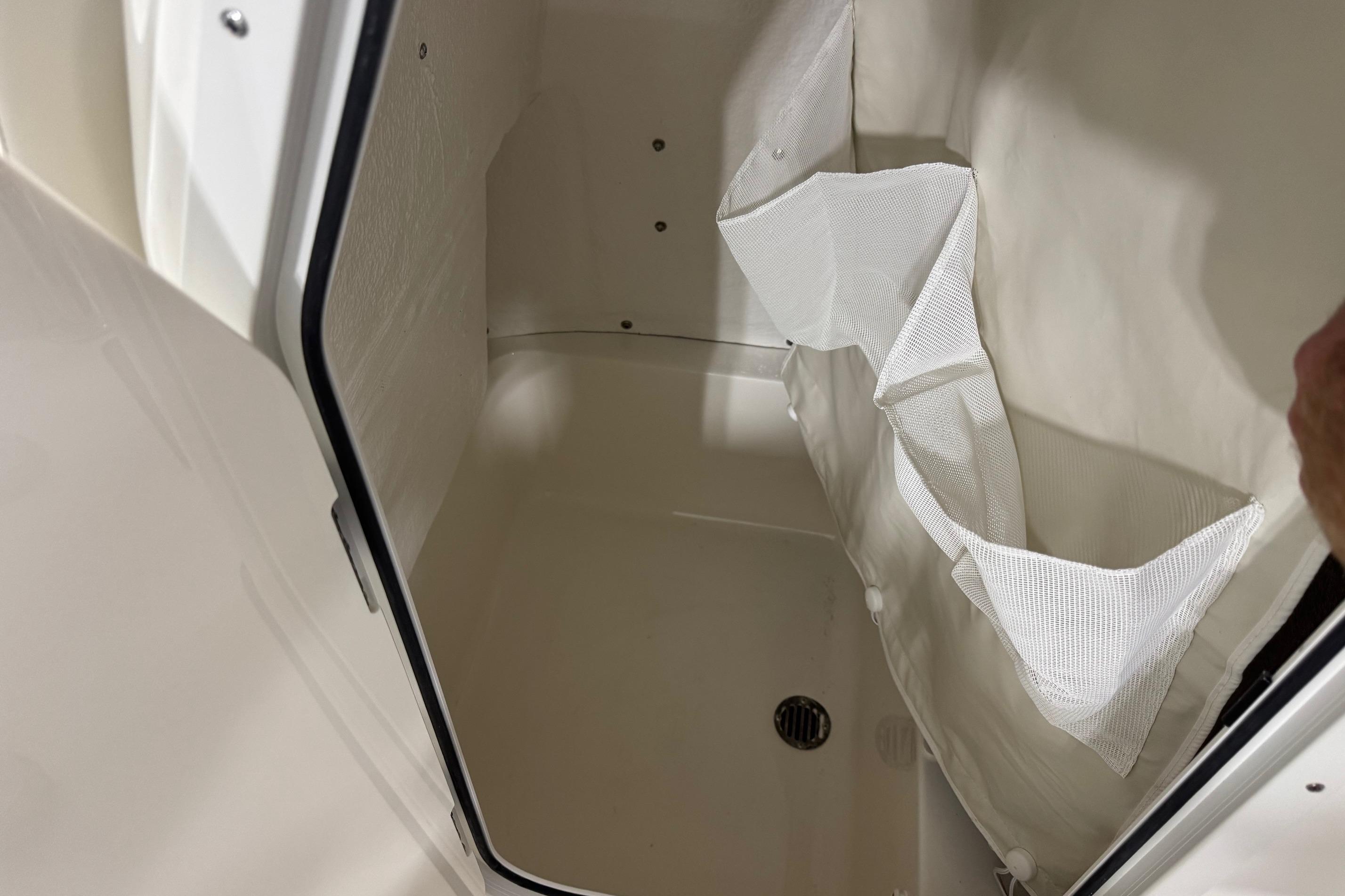Interior storage compartment of 2026 Key West 210 Bay Reef boat with mesh pockets.