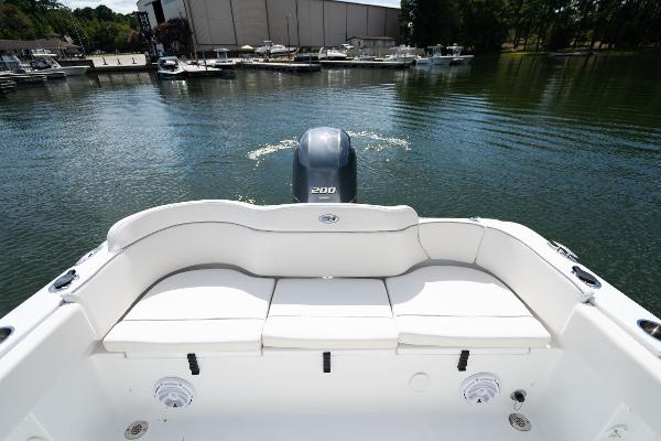 2024 Sea Hunt Ultra 234 boat stern view with seating and outboard motor.