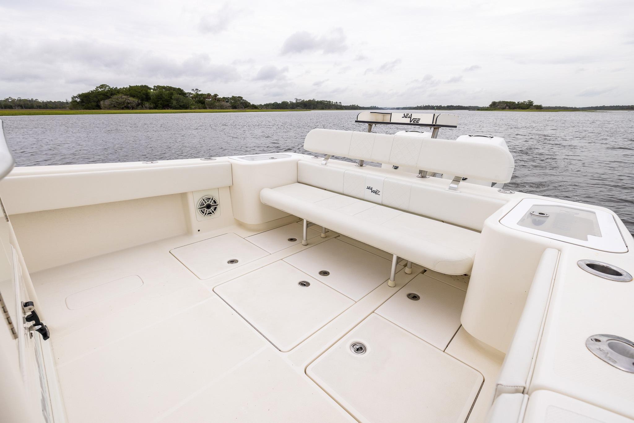 2019 SeaVee 322Z boat interior with spacious seating, set against a serene water backdrop.