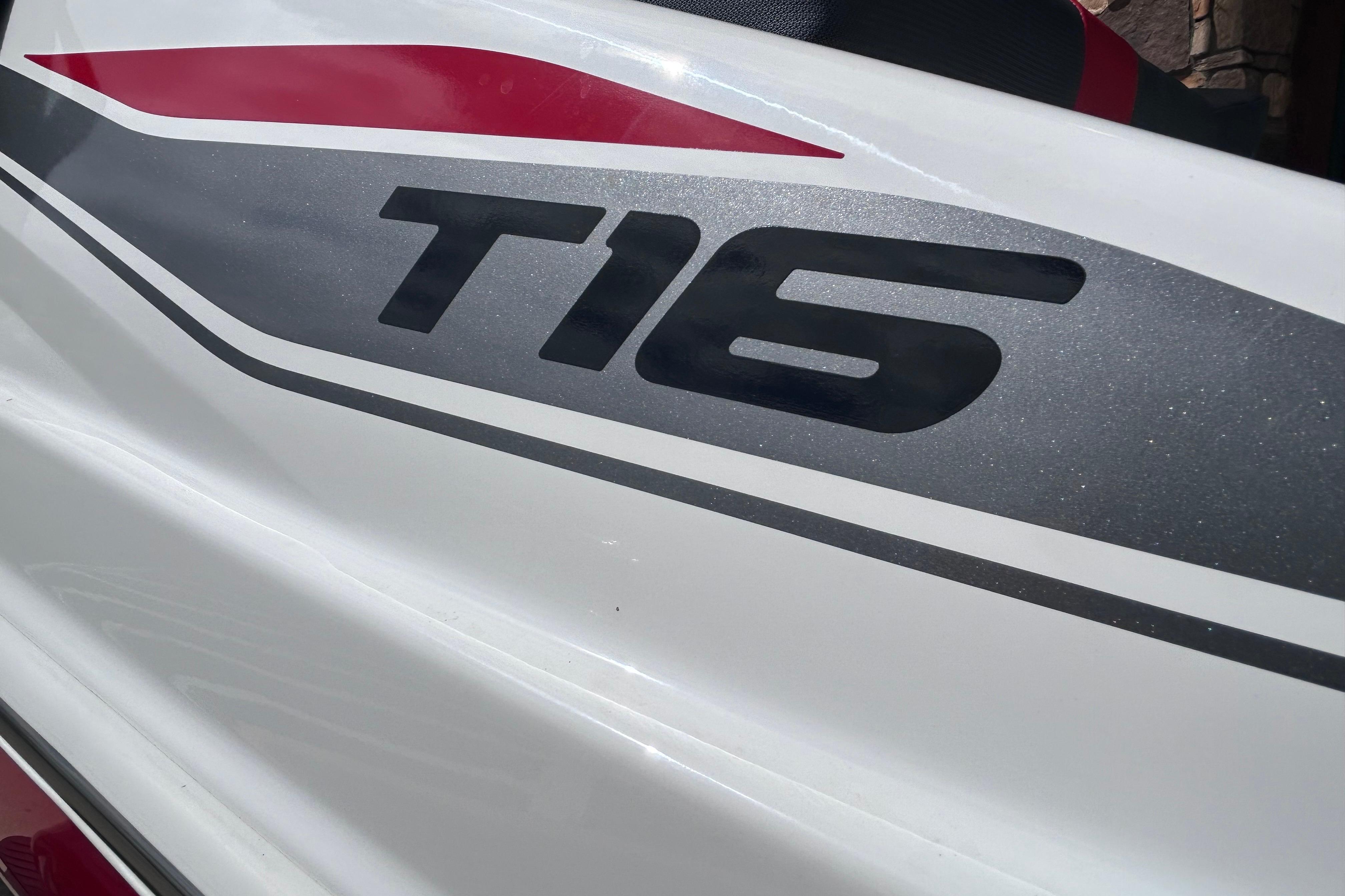 Close-up of 2026 Tahoe T16 model logo on sleek white surface.