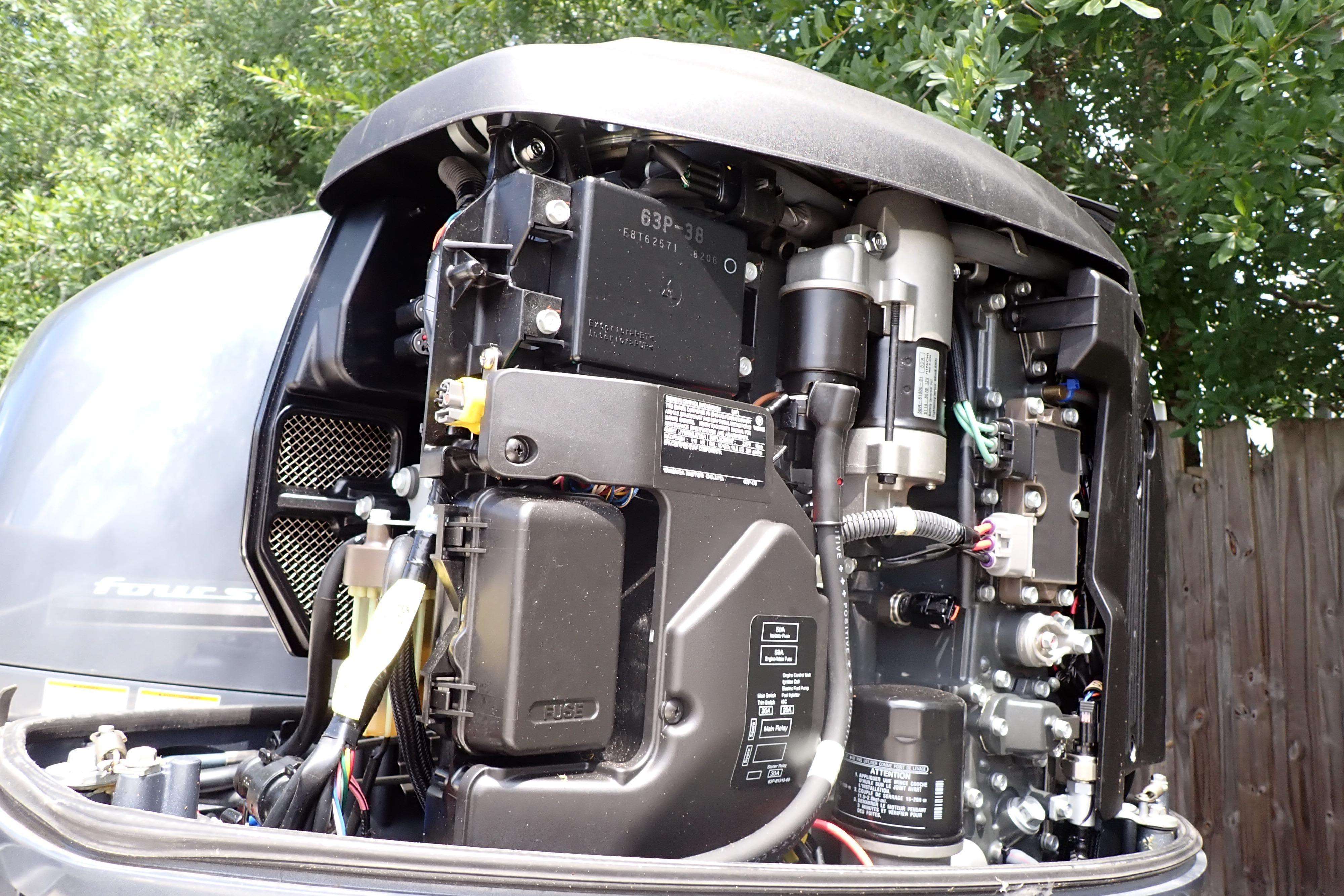 Close-up of a 2019 Key West 263 FS boat engine, showcasing intricate mechanical components.
